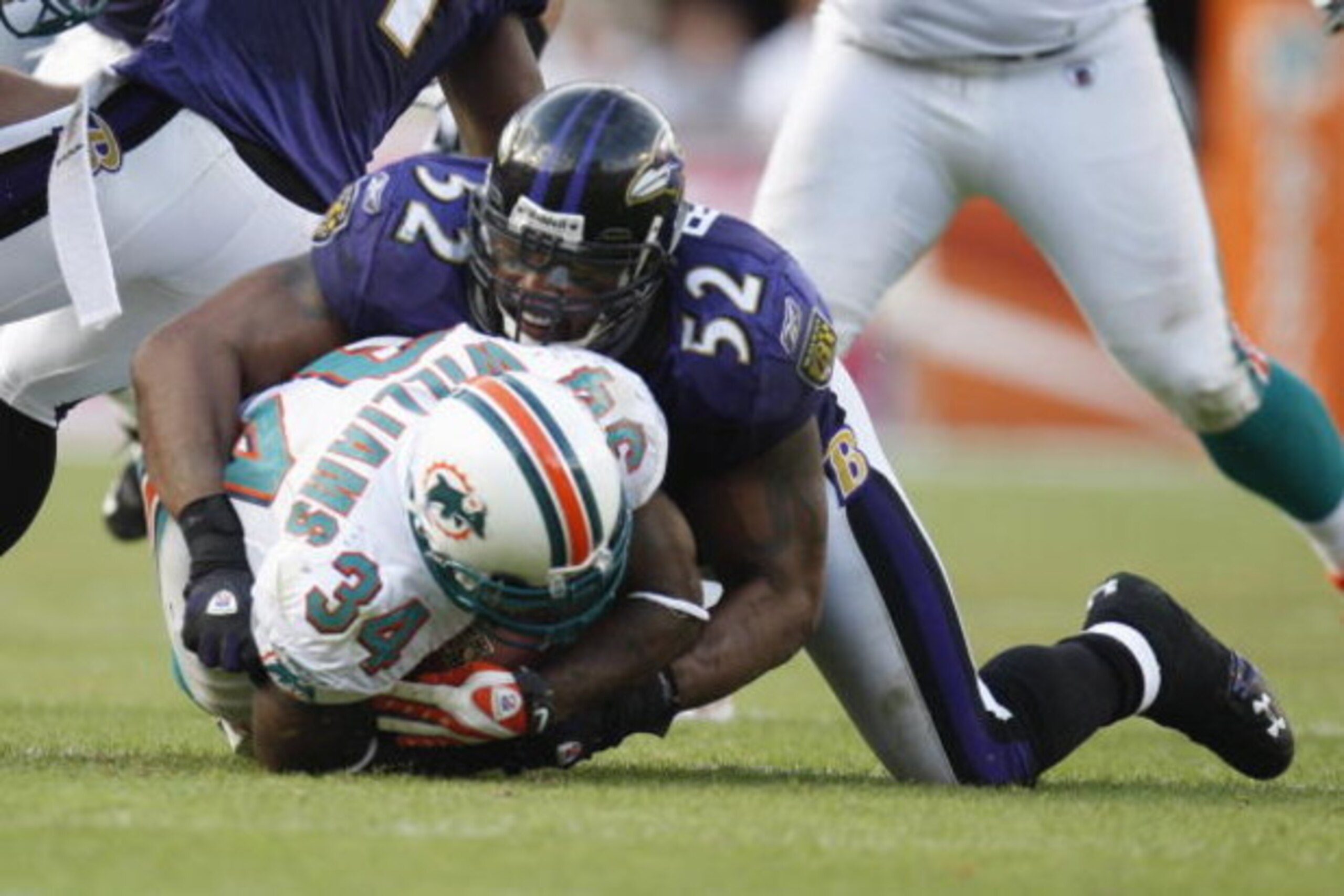 MIAMI - JANUARY 4:  Ray Lewis #52 of the Baltimore Ravens tackles Ricky Williams #34 of the Miami Dolphins during an AFC Wild Card playoff game on January 4, 2009 at Dolphin Stadium in Miami, Florida. (Photo by Gregory Shamus/Getty Images)