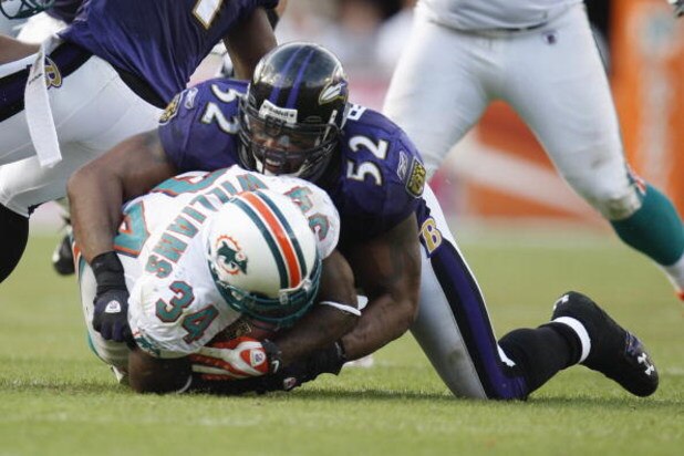 MIAMI - JANUARY 4:  Ray Lewis #52 of the Baltimore Ravens tackles Ricky Williams #34 of the Miami Dolphins during an AFC Wild Card playoff game on January 4, 2009 at Dolphin Stadium in Miami, Florida. (Photo by Gregory Shamus/Getty Images)