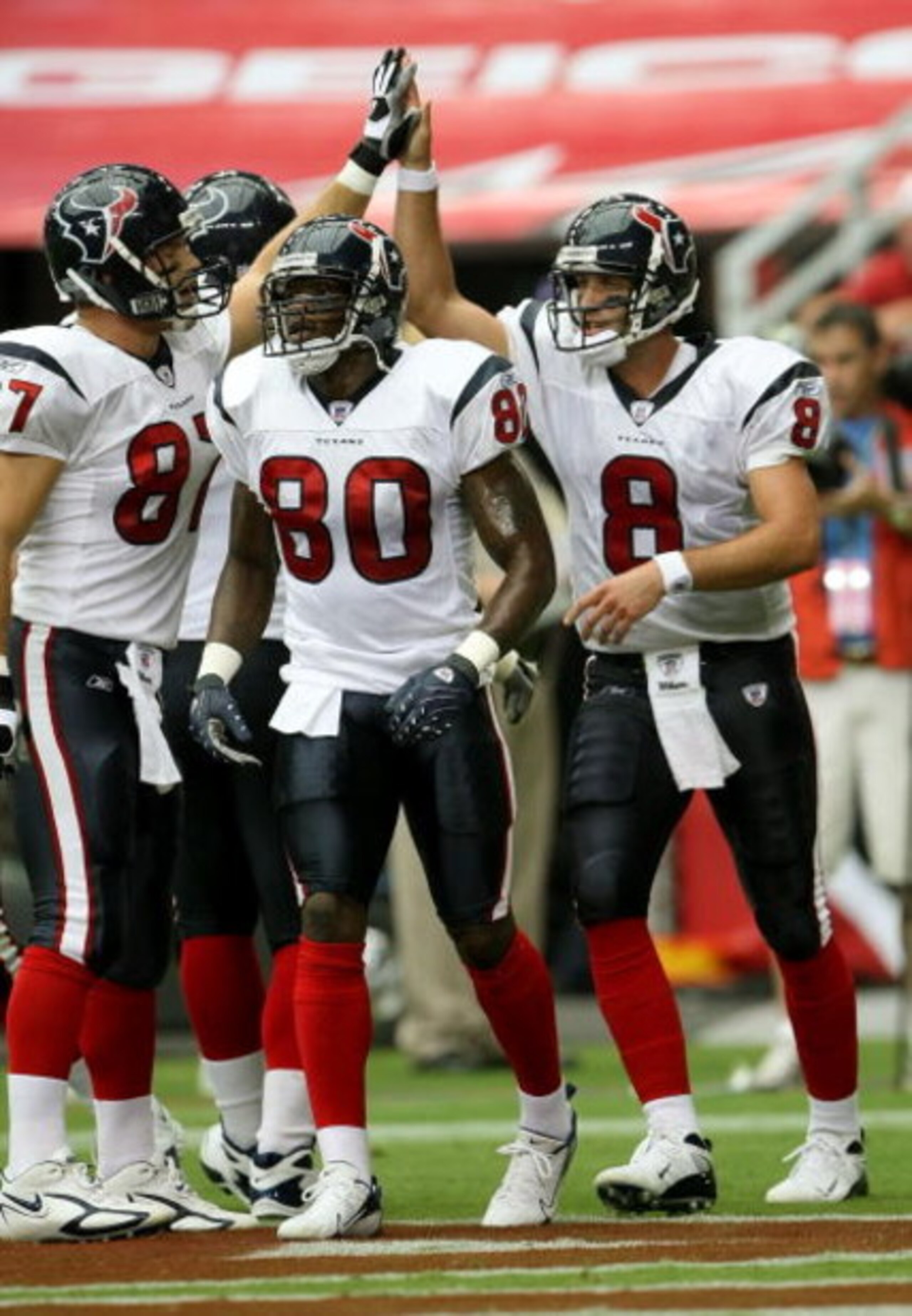 GLENDALE, AZ - AUGUST 18:  Quarterback Matt Schaub #8 of the Houston Texans celebrates with receivers Andre Johnson #80 and Mark Bruener #87 after running five yards for a touchdown against the Arizona Cardinals during their NFL preseason game at Universi