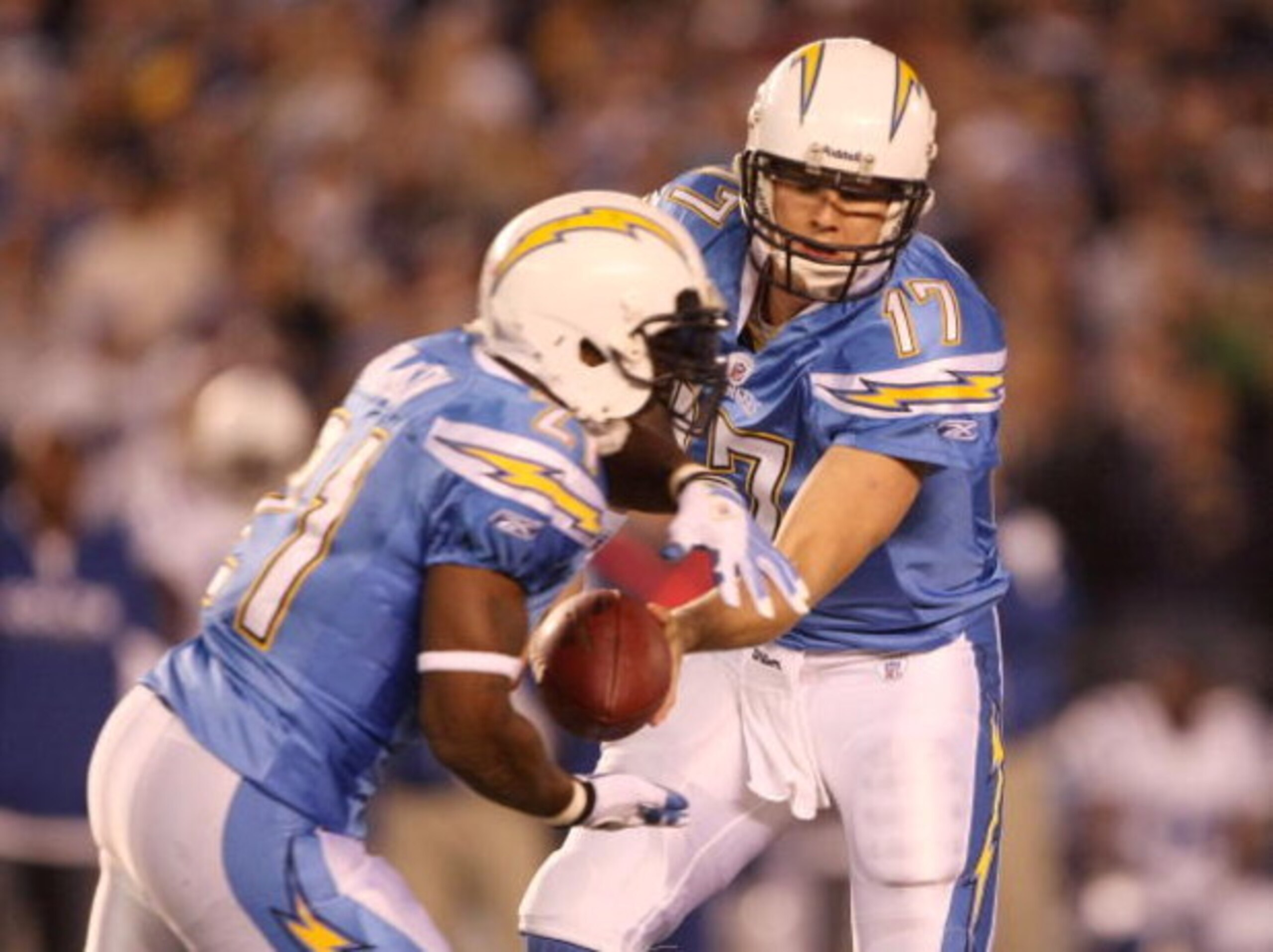 SAN DIEGO - JANUARY 03:  Philip Rivers #17 of the San Diego Chargers hands off the ball to LaDainian Tomlinson #21 during their game against the Indianapolis Colts in the AFC Wild Card Game on January 3, 2009 at Qualcomm Stadium in San Diego, California. 