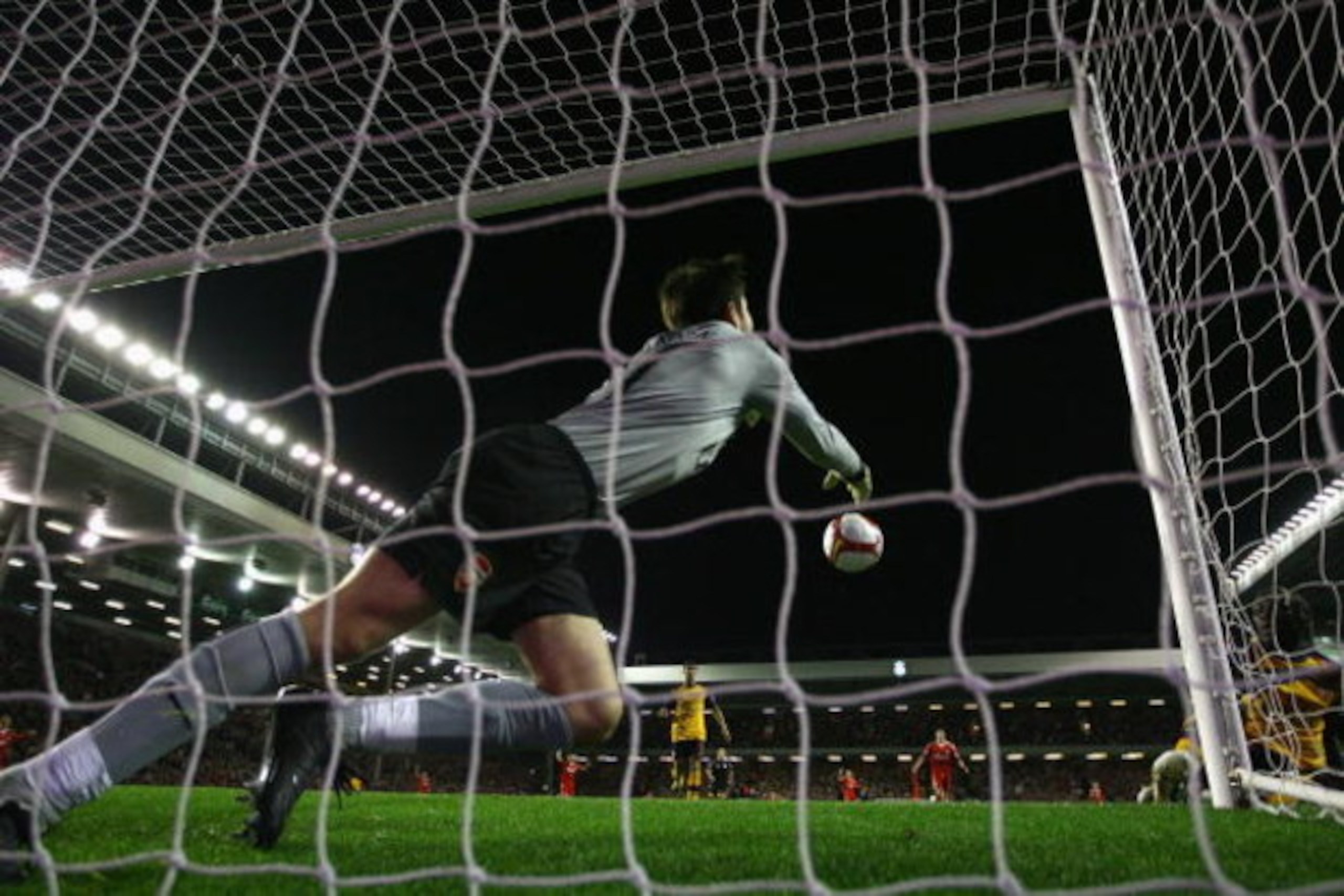 LIVERPOOL, UNITED KINGDOM - APRIL 21:  Lukasz Fabianski of Arsenal punches clear as Yossi Benayoun of Liverpool scores his team's second goal during the Barclays Premier League match between Liverpool and Arsenal at Anfield on April 21, 2009 in Liverpool,
