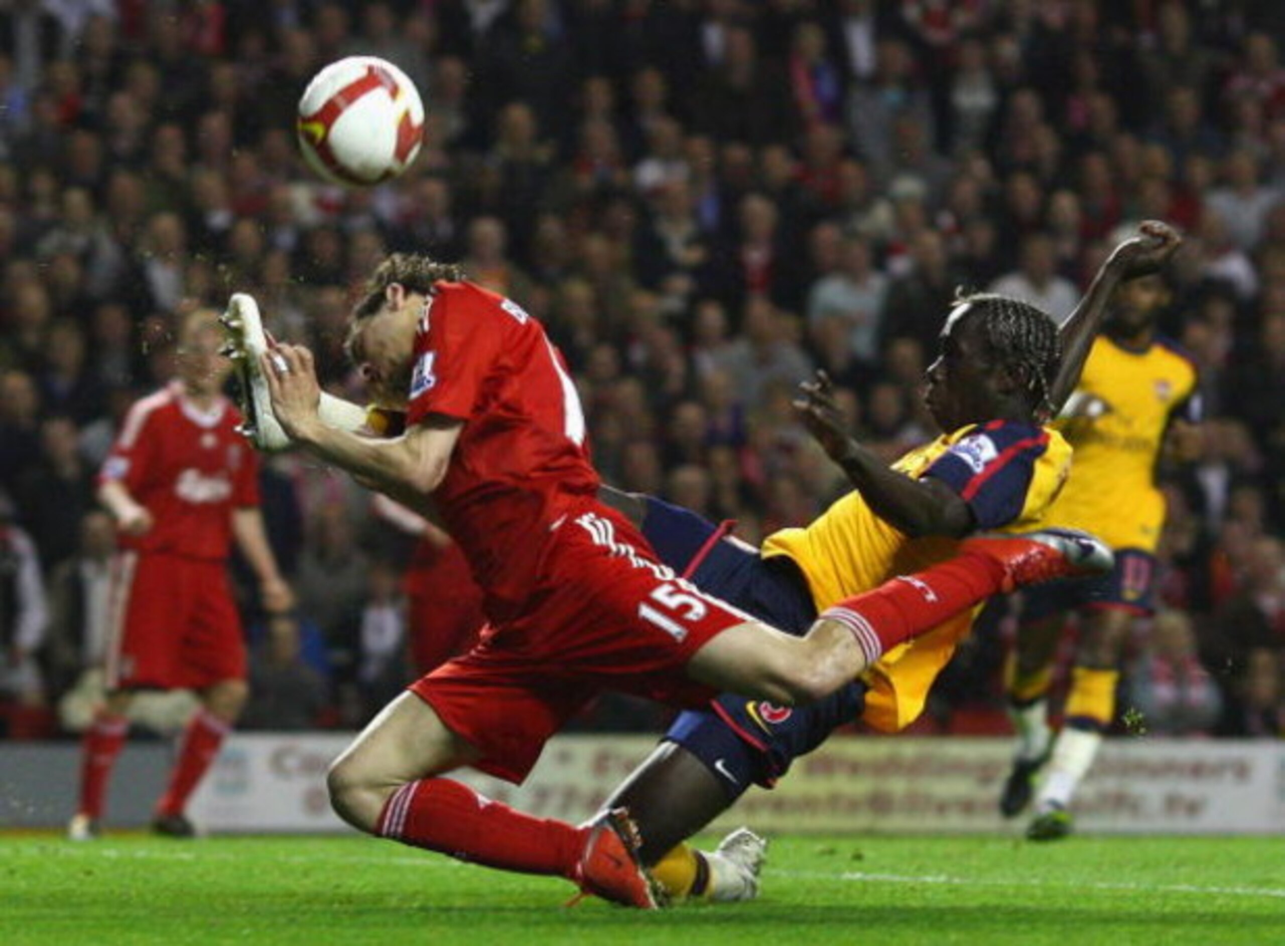 LIVERPOOL, UNITED KINGDOM - APRIL 21:   Yossi Benayoun of Liverpool tangles with Bacary Sagna of Arsenal prior to scoring his team's second goal during the Barclays Premier League match between Liverpool and Arsenal at Anfield on April 21, 2009 in Liverpo