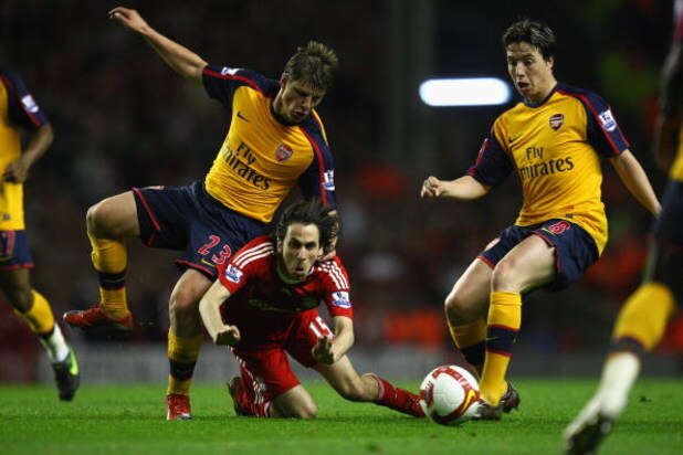 LIVERPOOL, UNITED KINGDOM - APRIL 21:  Andrey Arshavin of Arsenal  tangles with Yossi Benayoun of Liverpool during the Barclays Premier League match between Liverpool and Arsenal at Anfield on April 21, 2009 in Liverpool, England.  (Photo by Laurence Grif
