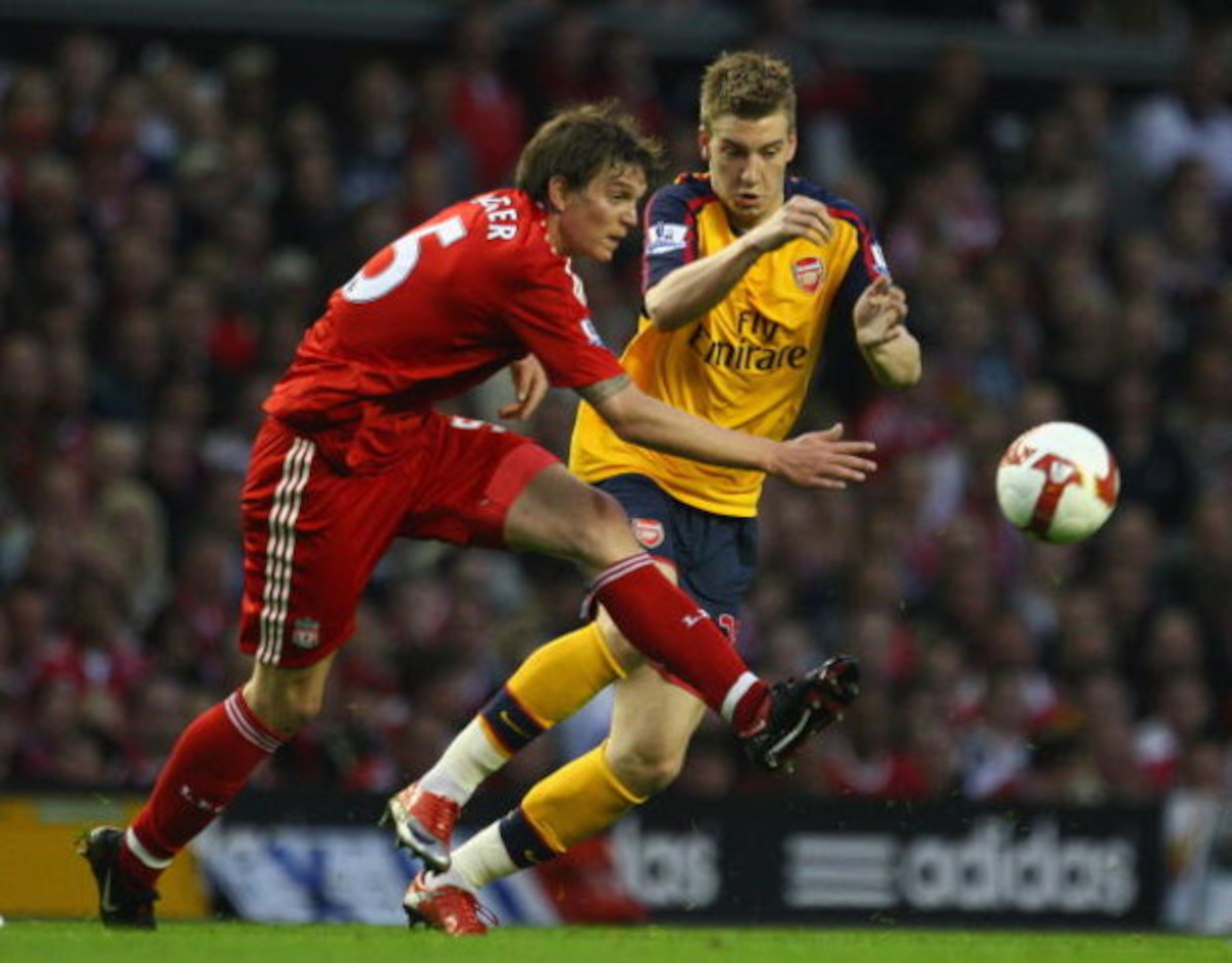 LIVERPOOL, UNITED KINGDOM - APRIL 21:  Nicklas Bendtner of Arsenal compets for the ball with Daniel Agger of Liverpool during the Barclays Premier League match between Liverpool and Arsenal at Anfield on April 21, 2009 in Liverpool, England. (Photo by Lau