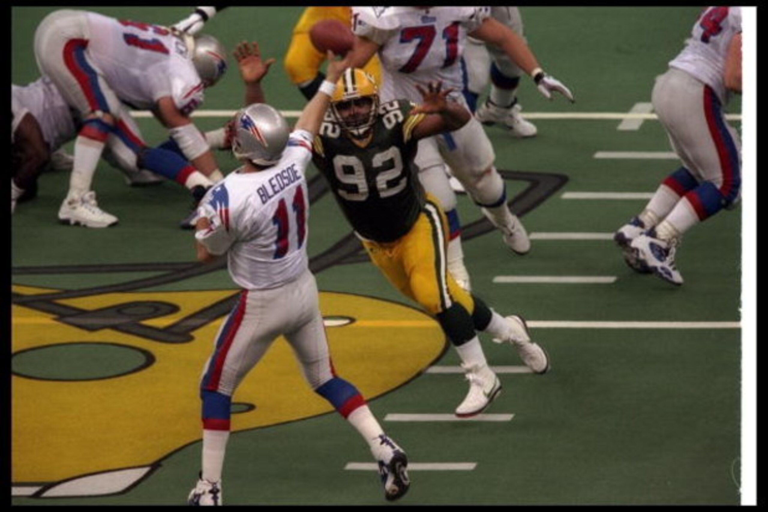 26 Jan 1997:  Defensive lineman Reggie White of the Green Bay Packers closes in on New England Patriots quarterback Drew Bledsoe during Super Bowl XXXI at the Superdome in New Orleans, Louisiana.  The Packers won the game, 35-21. Mandatory Credit: Stephen