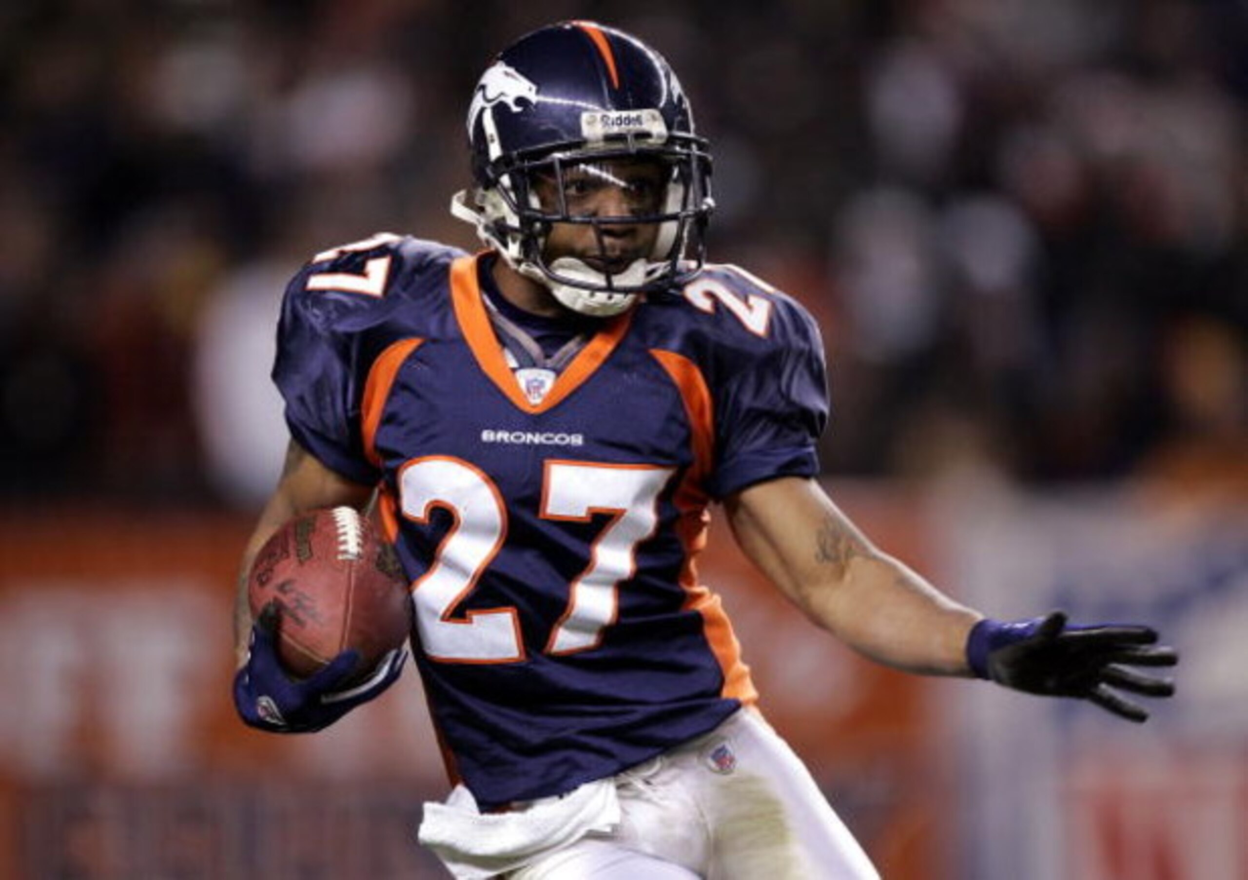 DENVER - JANUARY 14: Cornerback  Darrent Williams #27 of the Denver Broncos runs with the ball during the AFC Divisional Playoff game against the New England Patriots on January 14, 2006 at Invesco Field at Mile High in Denver, Colorado.  (Photo by Brian 