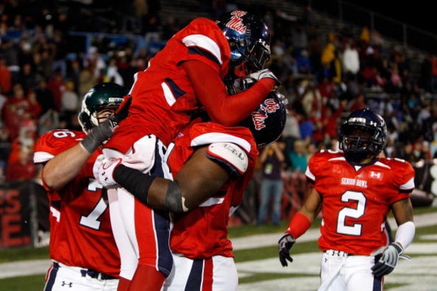 MOBILE, AL - JANUARY 24: Mike Wallace #9 and Michael Oher #74 of the South Team celebrate after Wallace scored a touchdown against the North Team during the Under Armour Senior Bowl on January 24, 2009 at Ladd-Peebles Stadium in Mobile, Alabama. (Photo by