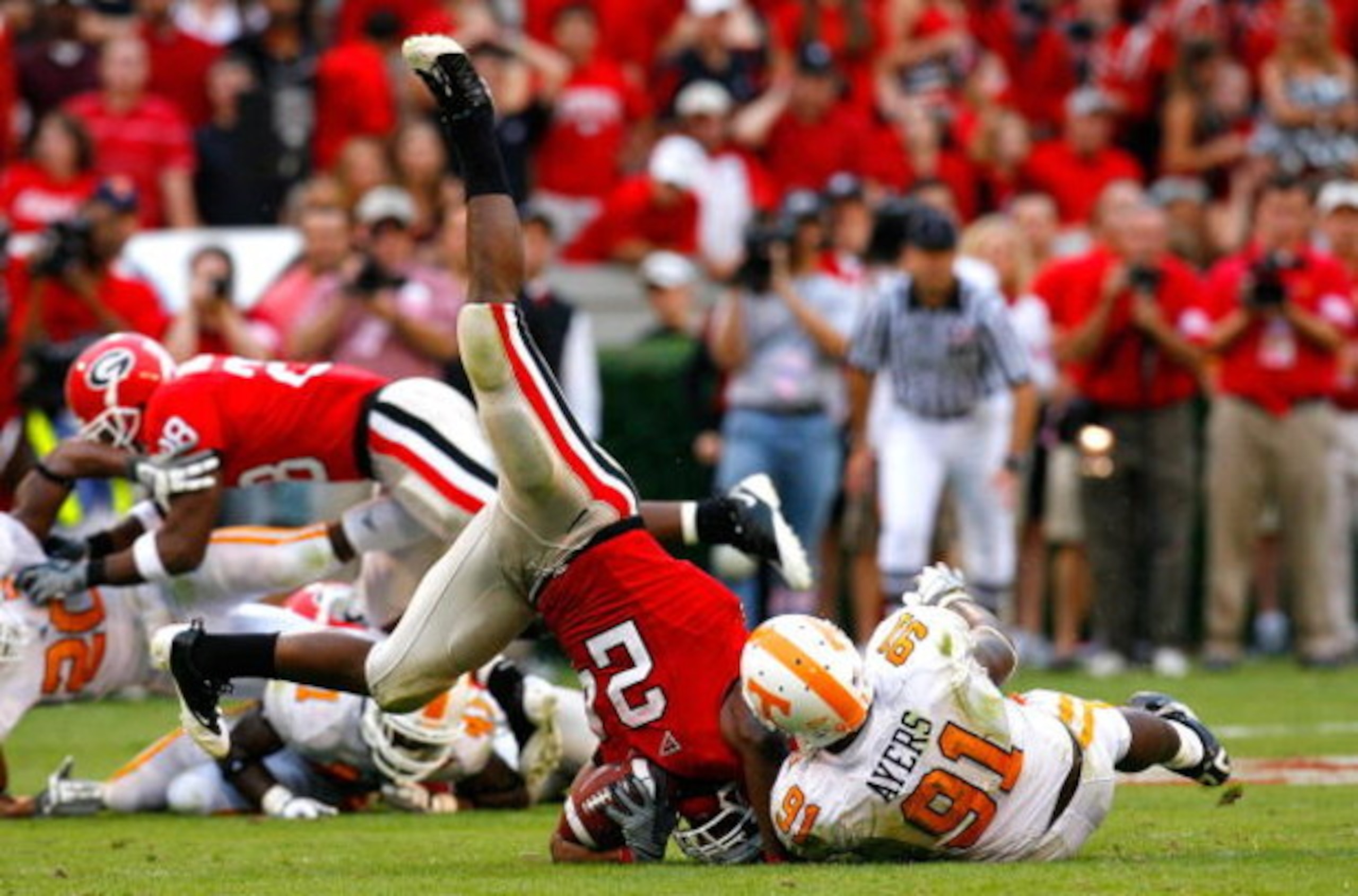 ATHENS, GA - OCTOBER 11: Robert Ayers #91 of the Tennessee Volunteers tackles and flips Knowshon Moreno #24 of the Georgia Bulldogs during the game at Sanford Stadium on October 11, 2008 in Athens, Georgia. (Photo by Kevin C. Cox/Getty Images) ATHENS, GA - OCTOBER 11: Robert Ayers #91 of the Tennessee Volunteers tackles and flips Knowshon Moreno #24 of the Georgia Bulldogs during the game at Sanford Stadium on October 11, 2008 in Athens, Georgia. (Photo by Kevin C. Cox/Getty Images)