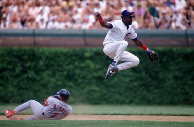 25 JUN 1994:  RUNNER OZZIE SMITH #1 OF THE ST. LOUIS CARDINALS SLIDES INTO SECOND BASE AS INFIELDER SHAWON DUNSTON OF THE CHICAGO CUBS TURNS A DOUBLE PLAY DURING THE CUBS 3-1 WIN AT WRIGLEY FIELD IN CHICAGO, ILLINOIS. Mandatory Credit: Jonathan Daniel/ALL