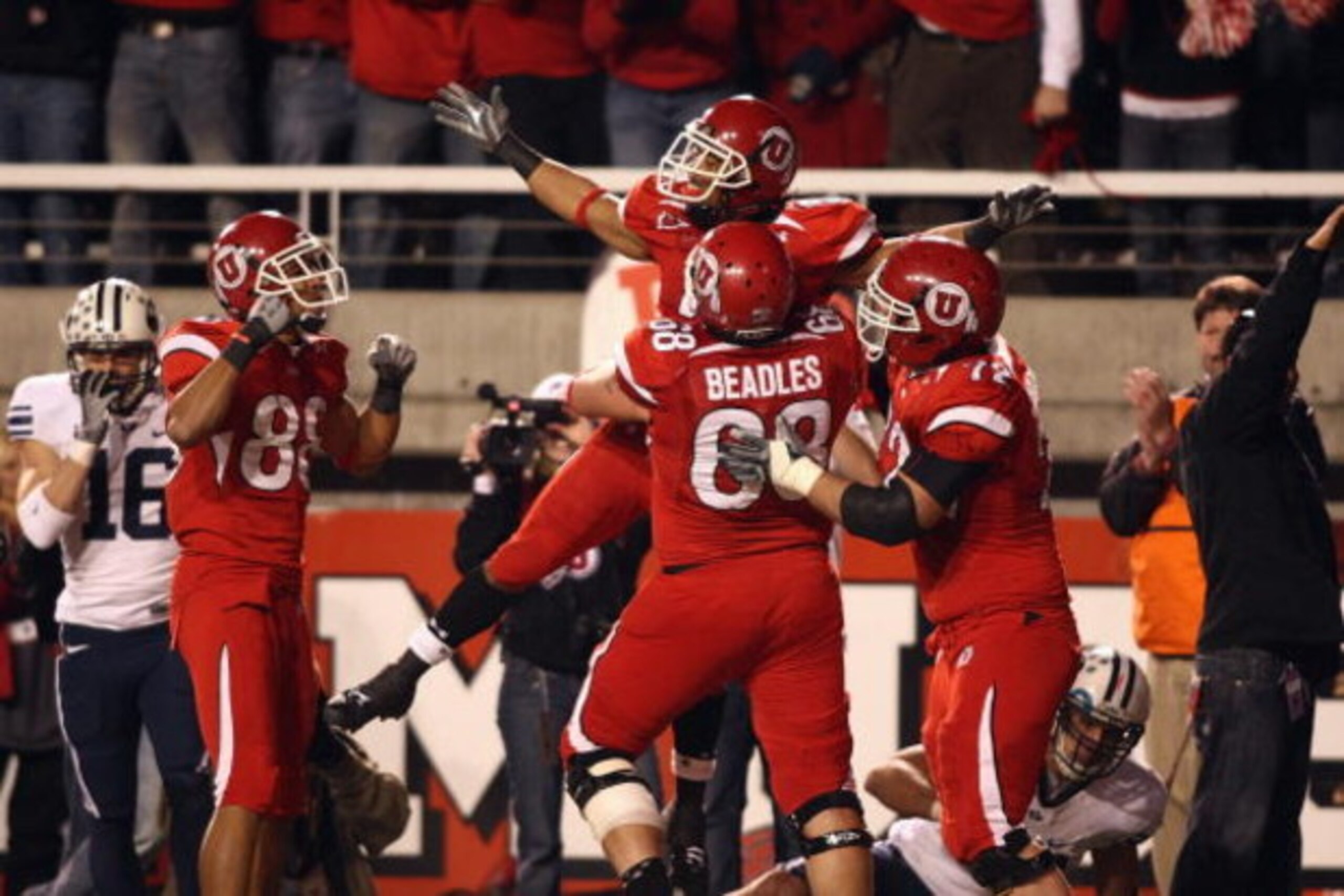 SALT LAKE CITY, UT - NOVEMBER 22:  Brent Casteel #5  of the Utah Utes celebrates with teammates Freddie Brown #88, Zane Beadles #68 and Caleb Schlauderaff #72 during the game against the BYU Cougars at Rice-Eccles Stadium on November 22, 2008 in Salt Lake
