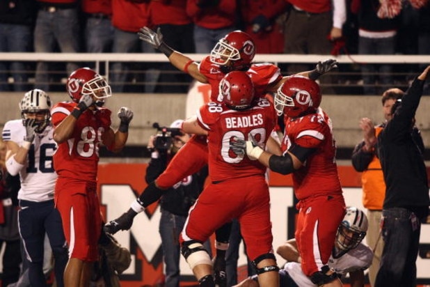 SALT LAKE CITY, UT - NOVEMBER 22:  Brent Casteel #5  of the Utah Utes celebrates with teammates Freddie Brown #88, Zane Beadles #68 and Caleb Schlauderaff #72 during the game against the BYU Cougars at Rice-Eccles Stadium on November 22, 2008 in Salt Lake