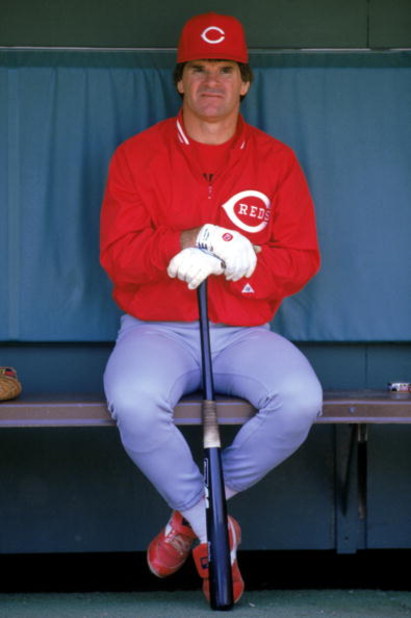1986:  Pete Rose of the Cincinnati Reds sits in the dug-out during a MLB game in the 1986 season. ( Photo by: Stephen Dunn/Getty Images)