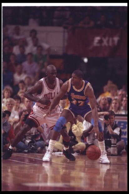 2 May 1991:  Guard Michael Jordan of the Chicago Bulls (left) and guard Magic Johnson of the Los Angeles Lakers fight for the ball during Game One of the NBA finals at the United Center in Chicago, Illinois.  The Lakers won the game, 93-91. Mandatory Cred