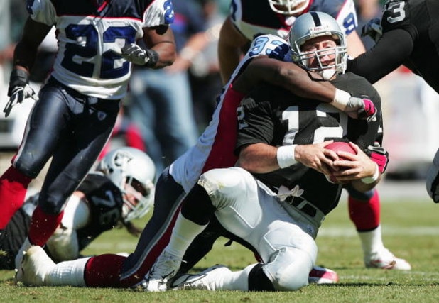 OAKLAND, CA - SEPTEMBER 19:  Rich Gannon #12 of the Oakland Raiders is sacked by Pat Williams #93 of the Buffalo Bills at Network Associates Coliseum on September 19, 2004 in Oakland, California. (Photo by Jed Jacobsohn/Getty Images)