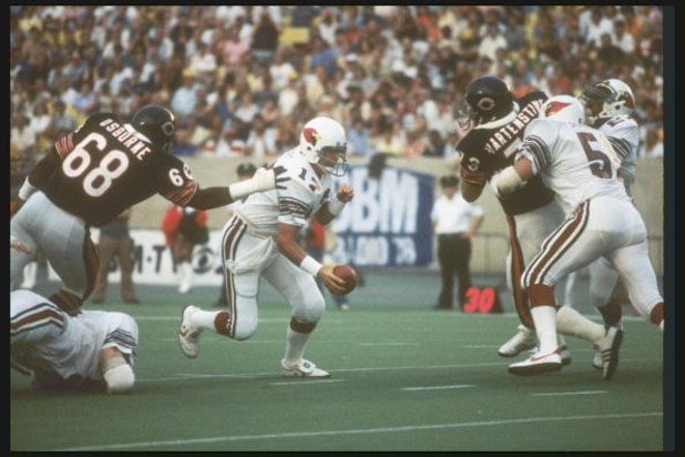 30 Aug 1980:  St Louis Cardinals quarterback Jim Hart avoids the grasp of a Chicago Bears defensive lineman during a preseason game at Soldier Field in Chicago, Illinois.  Mandatory Credit: Jonathan Daniel  /Allsport