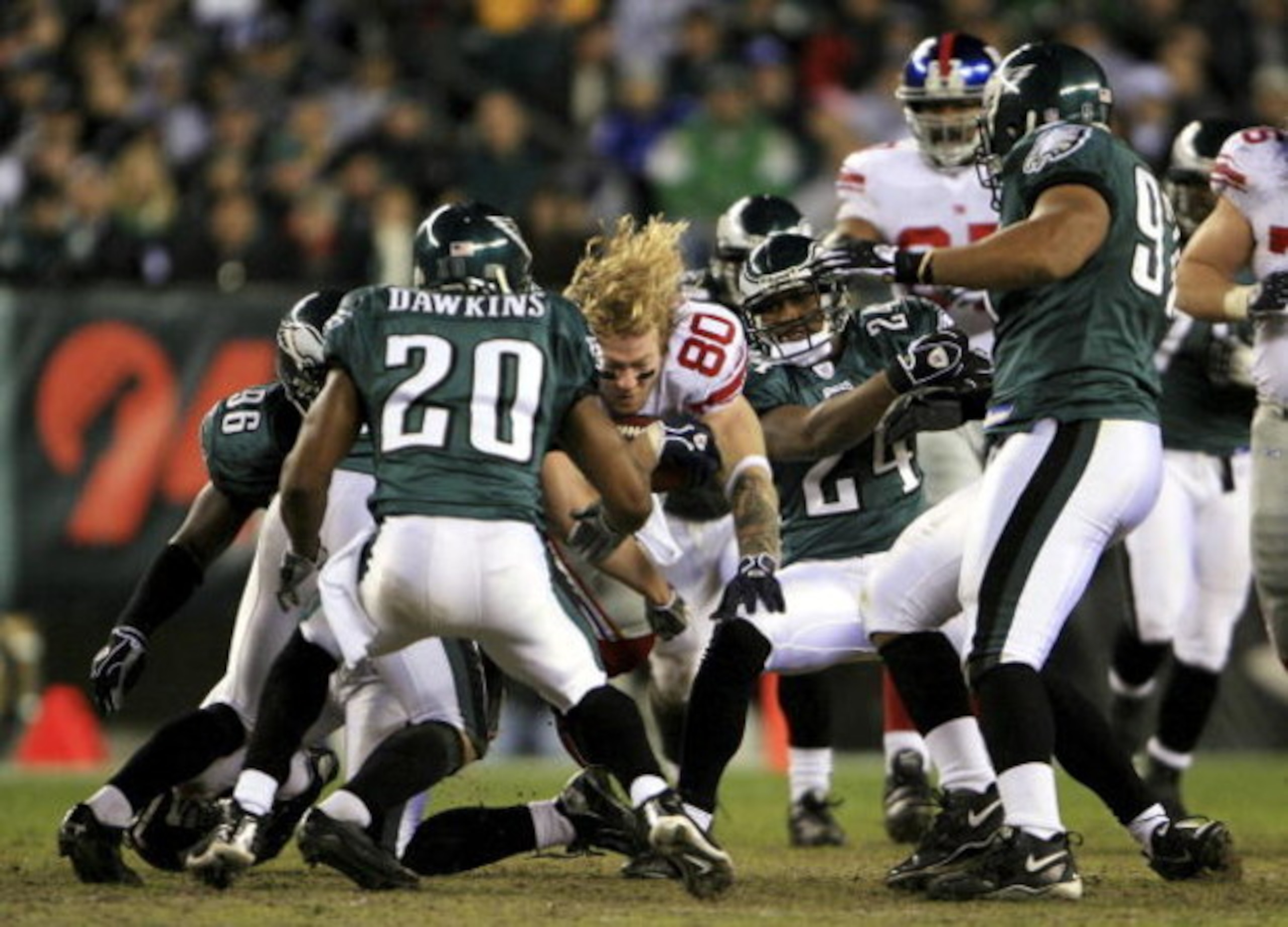 PHILADELPHIA - JANUARY 07:  Jeremy Shockey #80 of the New York Giants reaches for more yardage after having his helmet knocked off by the Philadelphia Eagles during their NFC Wildcard Playoff game on January 7, 2007 at Lincoln Financial Field in Philadelp