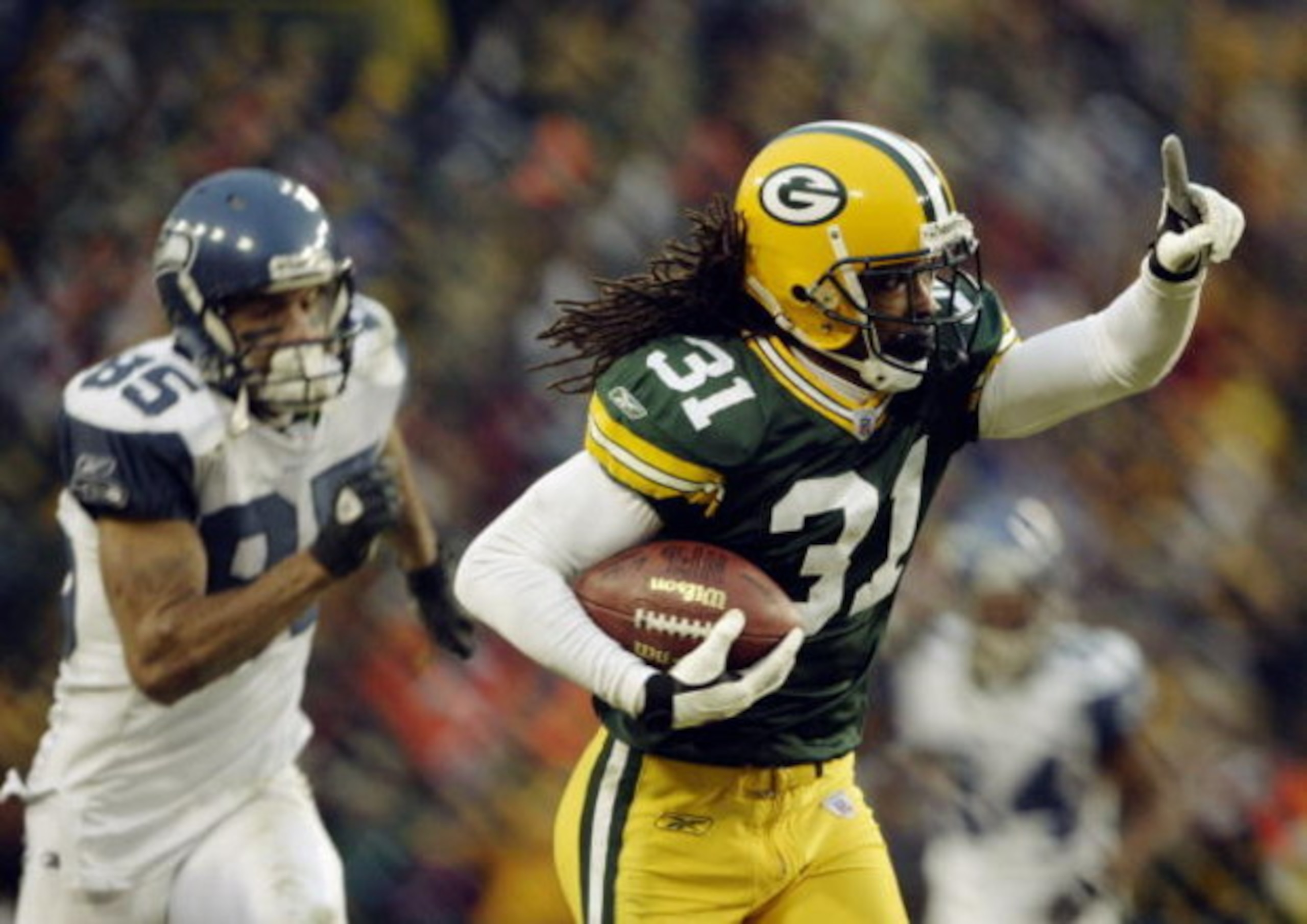 GREEN BAY, WI - JANUARY 4:  Cornerback Al Harris #31 of the Green Bay Packers returns an interception 52-yards for a touchdown in overtime to give the Packers a 33-27 victory in the NFC playoff game against the Seattle Seahawks on January 4, 2004 in Lambe