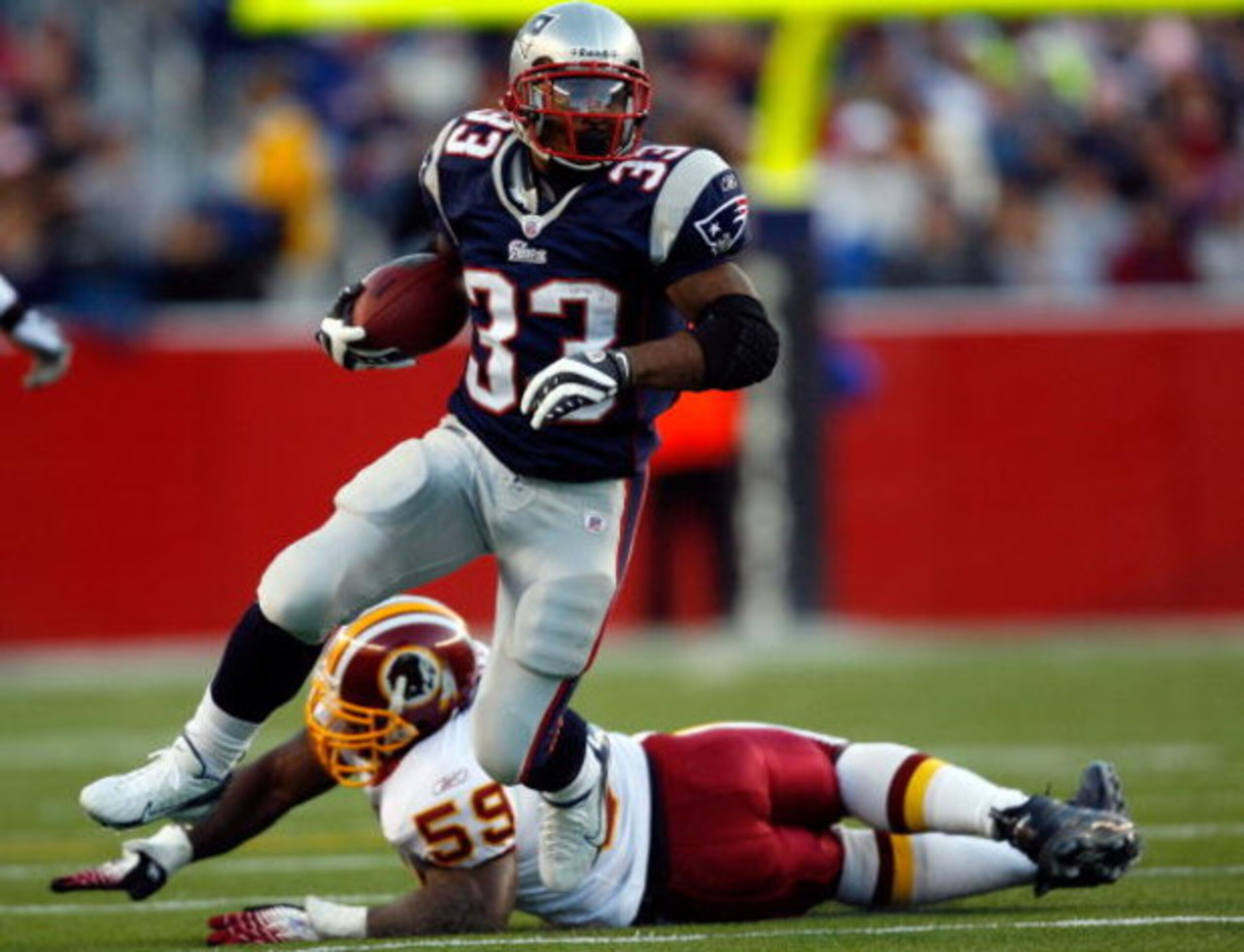 FOXBORO, MA - OCTOBER 28:  Kevin Faulk #33 of the New England Patriots carries the ball as London Fletcher #59 of the Washington Redskins misses the tackle on October 28, 2007 at Gillette Stadium in Foxboro, Massachusetts.  (Photo by Jim Rogash/Getty Imag
