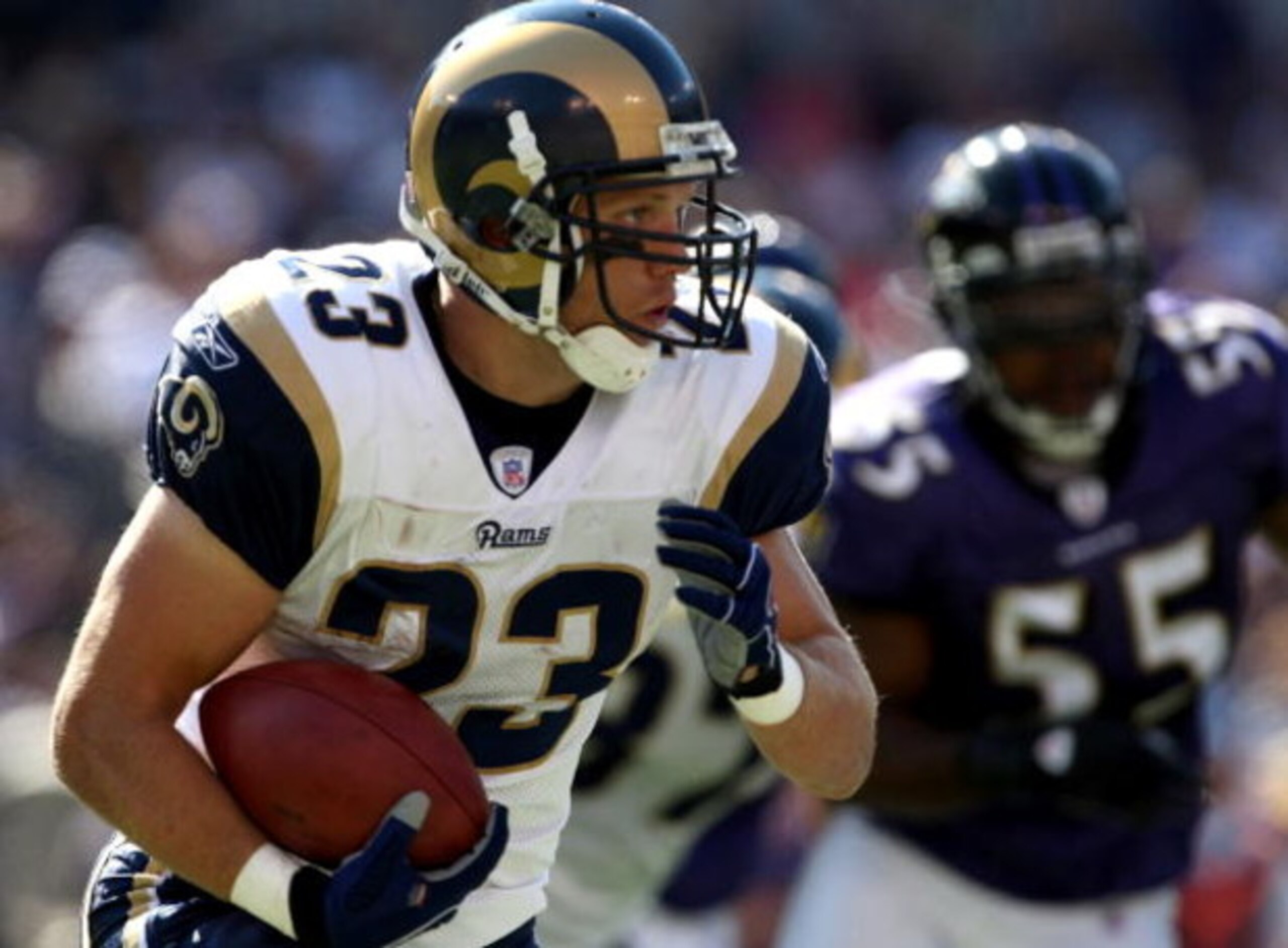 BALTIMORE - OCTOBER 14:  Brian Leonard #23 of the St. Louis Rams carries the ball as Terrell Suggs #55 of the Baltimore Ravens gives chase during the game at M&T Bank Stadium October 14, 2007 in Baltimore, Maryland.  (Photo by Jamie Squire/Getty Images)