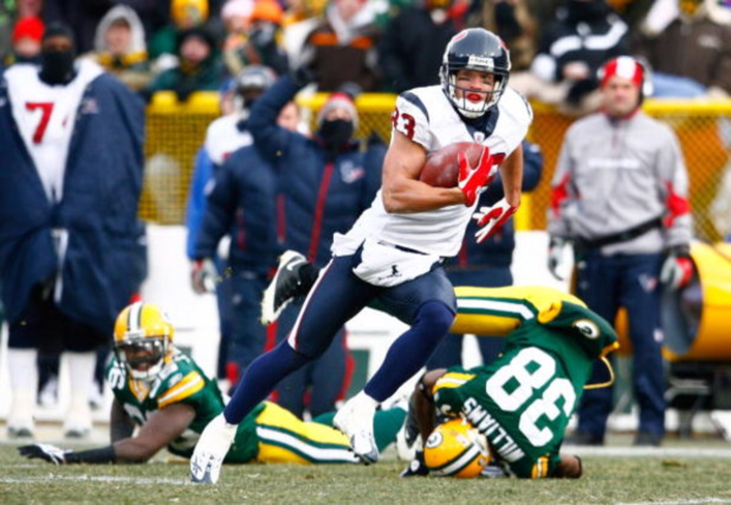 GREEN BAY, WI - DECEMBER 07:  Wide receiver Kevin Walter #83 of the Houston Texans runs for a touchdown after a reception during the first quarter against the Green Bay Packers at Lambeau Field on December 7, 2008 in Green Bay, Wisconsin.  (Photo by Jeff 