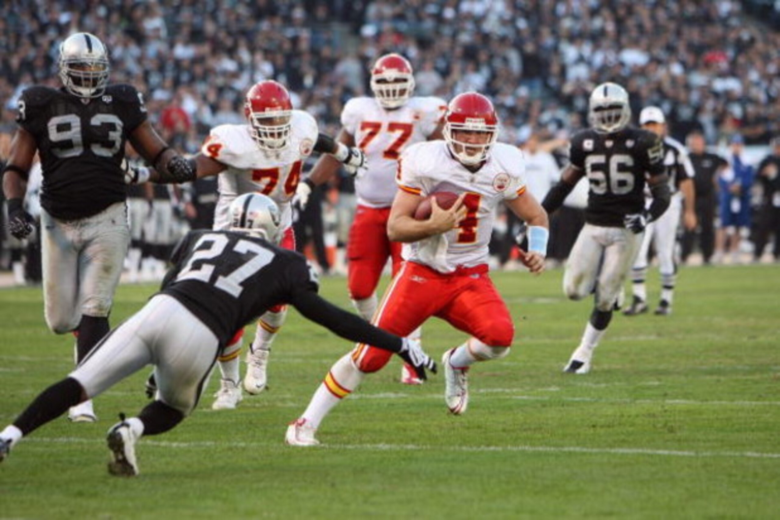 OAKLAND, CA - NOVEMBER 30:  Quarterback Tyler Thigpen #4 of the Kansas City Chiefs runs the ball against Rashad Baker #27 of the Oakland Raiders during an NFL game on November 30, 2008 at the Oakland-Alameda County Coliseum in Oakland, California. (Photo 