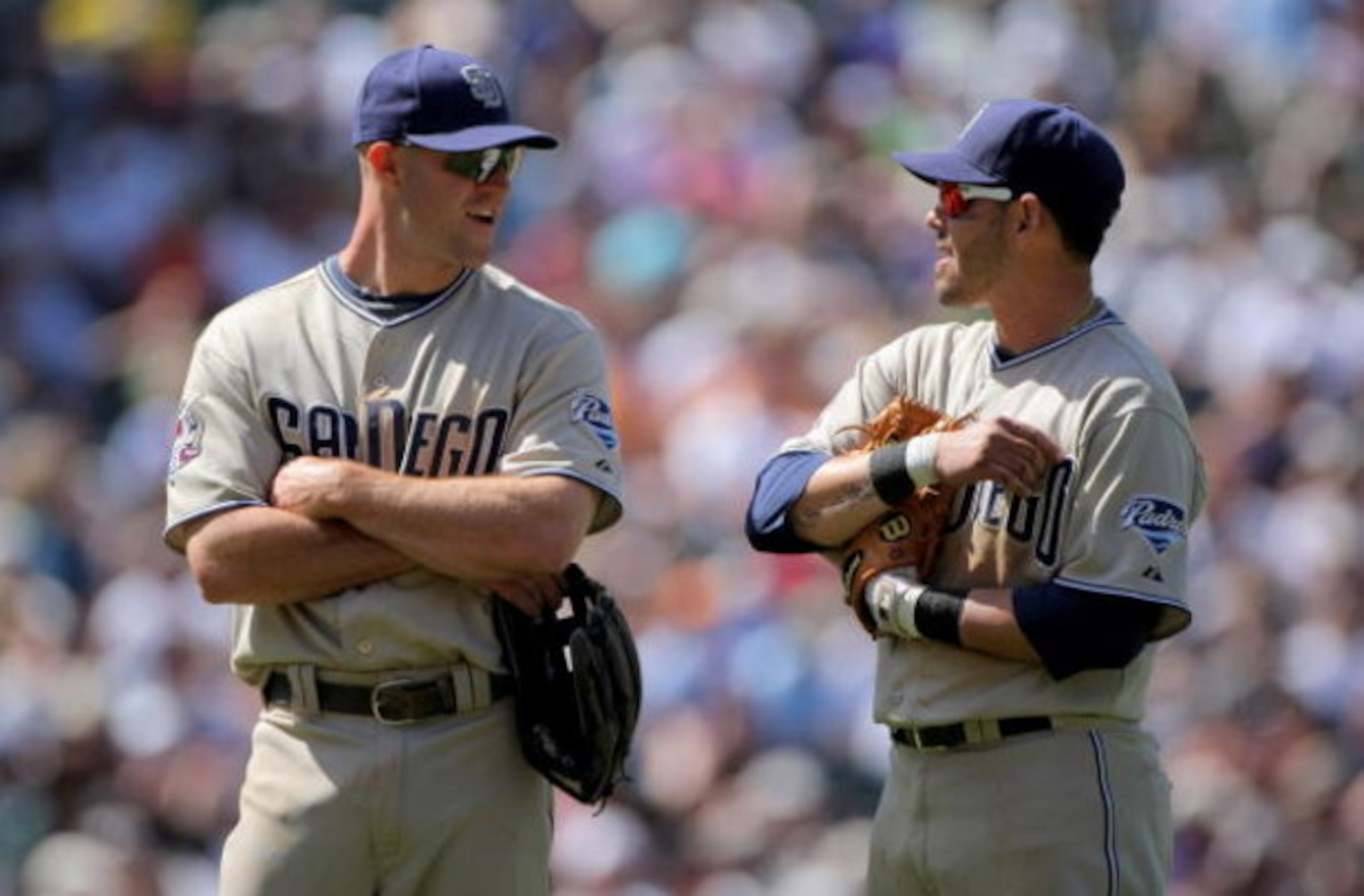 DENVER - APRIL 29: Third baseman Kevin Kouzmanoff #5 and shortstop Luis Rodriguez #15 of the San Diego Padres await a pitching change against the Colorado Rockies during MLB action at Coors Field on April 29, 2009 in Denver, Colorado. The Rockies defeate DENVER - APRIL 29: Third baseman Kevin Kouzmanoff #5 and shortstop Luis Rodriguez #15 of the San Diego Padres await a pitching change against the Colorado Rockies during MLB action at Coors Field on April 29, 2009 in Denver, Colorado. The Rockies defeate