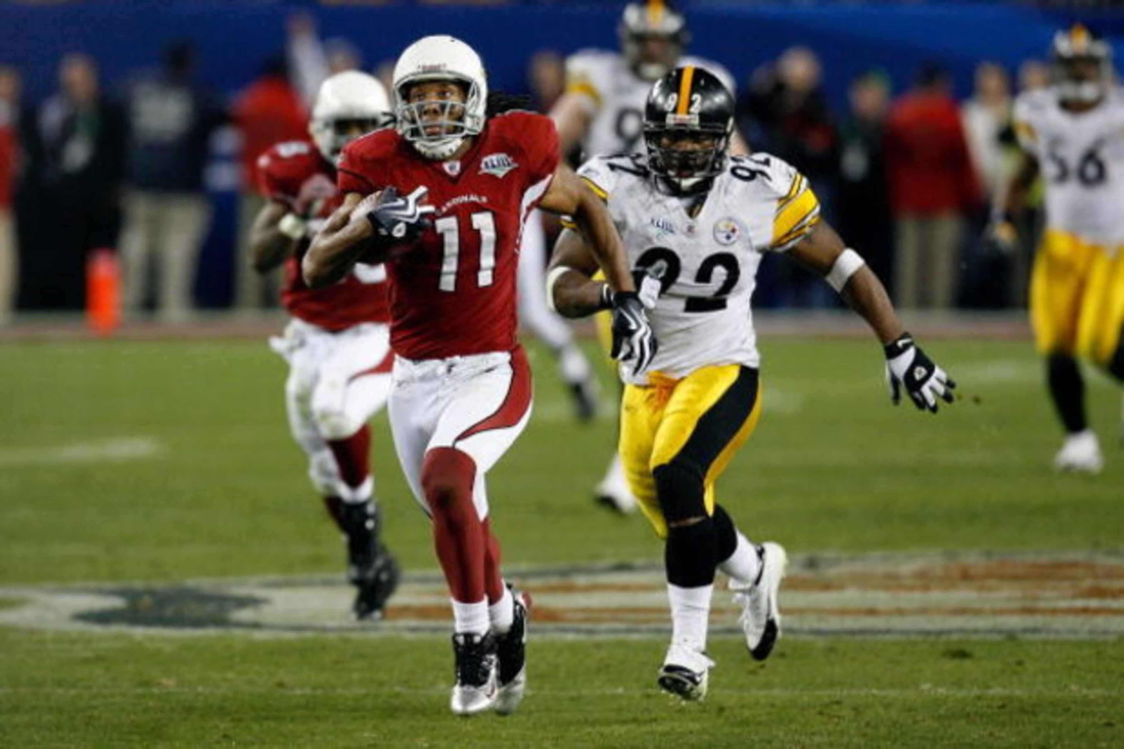 TAMPA, FL - FEBRUARY 01:  Wide receiver Larry Fitzgerald #11 of the Arizona Cardinals scores a 64-yard touchdown reception in the fourth quarter against James Harrison #92 of the Pittsburgh Steelers during Super Bowl XLIII on February 1, 2009 at Raymond J
