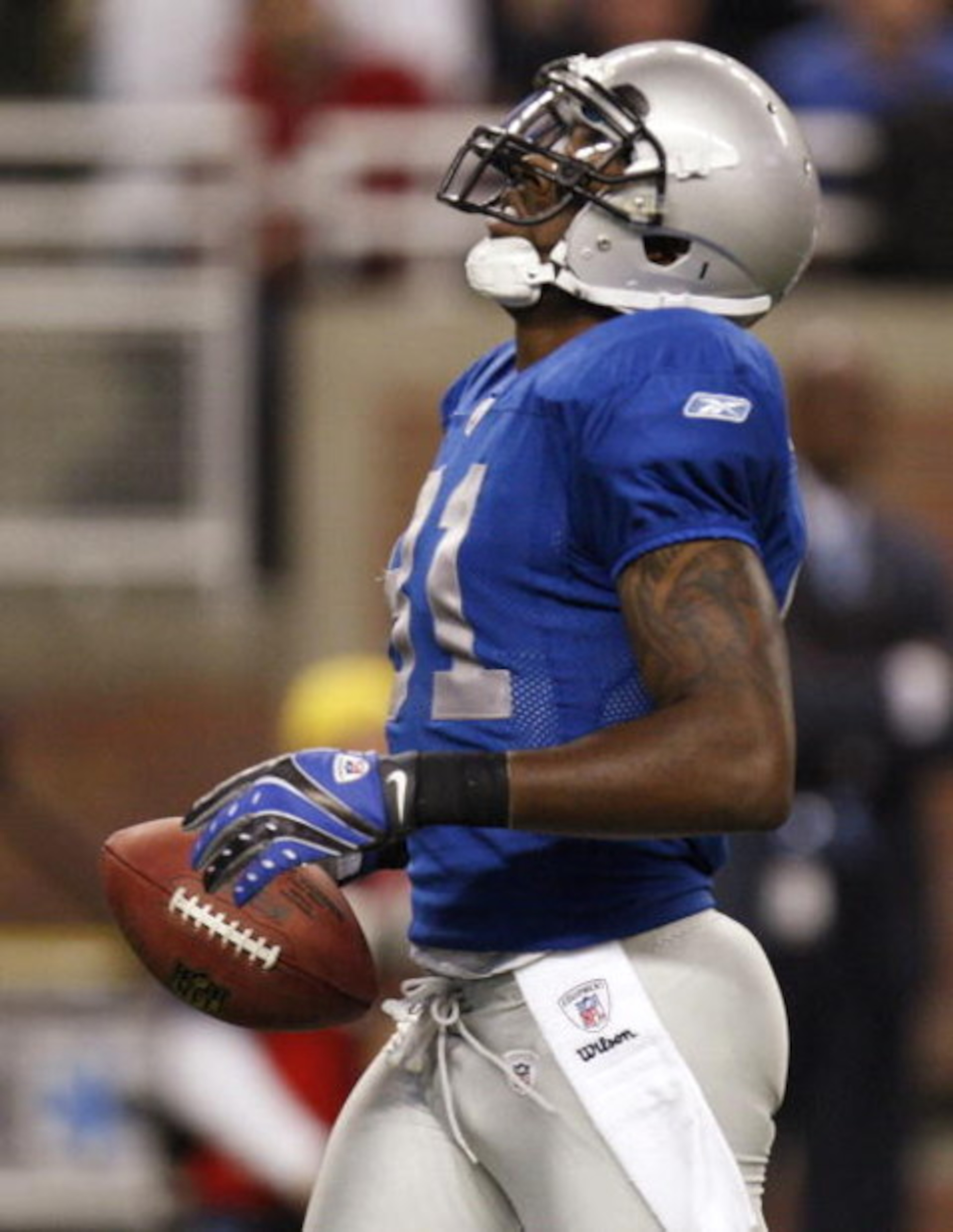DETROIT , MI - NOVEMBER 27:  Calvin Johnson #81 of the Detroit Lions reacts after dropping a first quarter pass while playing the Tennessee Titans on November 27, 2008 at Ford Field in Detroit, Michigan.  (Photo by Gregory Shamus/Getty Images)