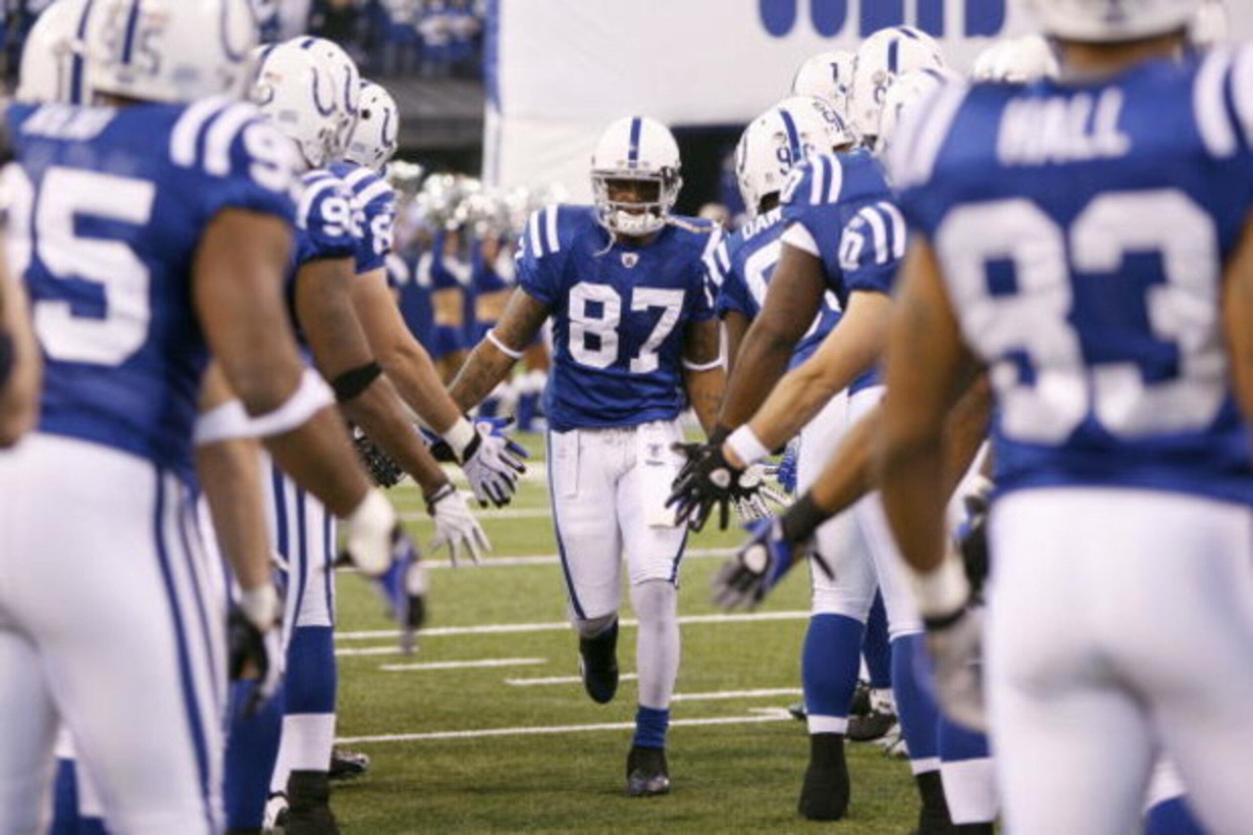 INDIANAPOLIS - DECEMBER 28:  Reggie Wayne #99 of the Indianapolis Colts greets teammates as he is introduced before the game against the Tennessee Titans on December 28, 2008 at Lucas Oil Stadium in Indianapolis, Indiana. (Photo by: Jamie Squire/Getty Ima