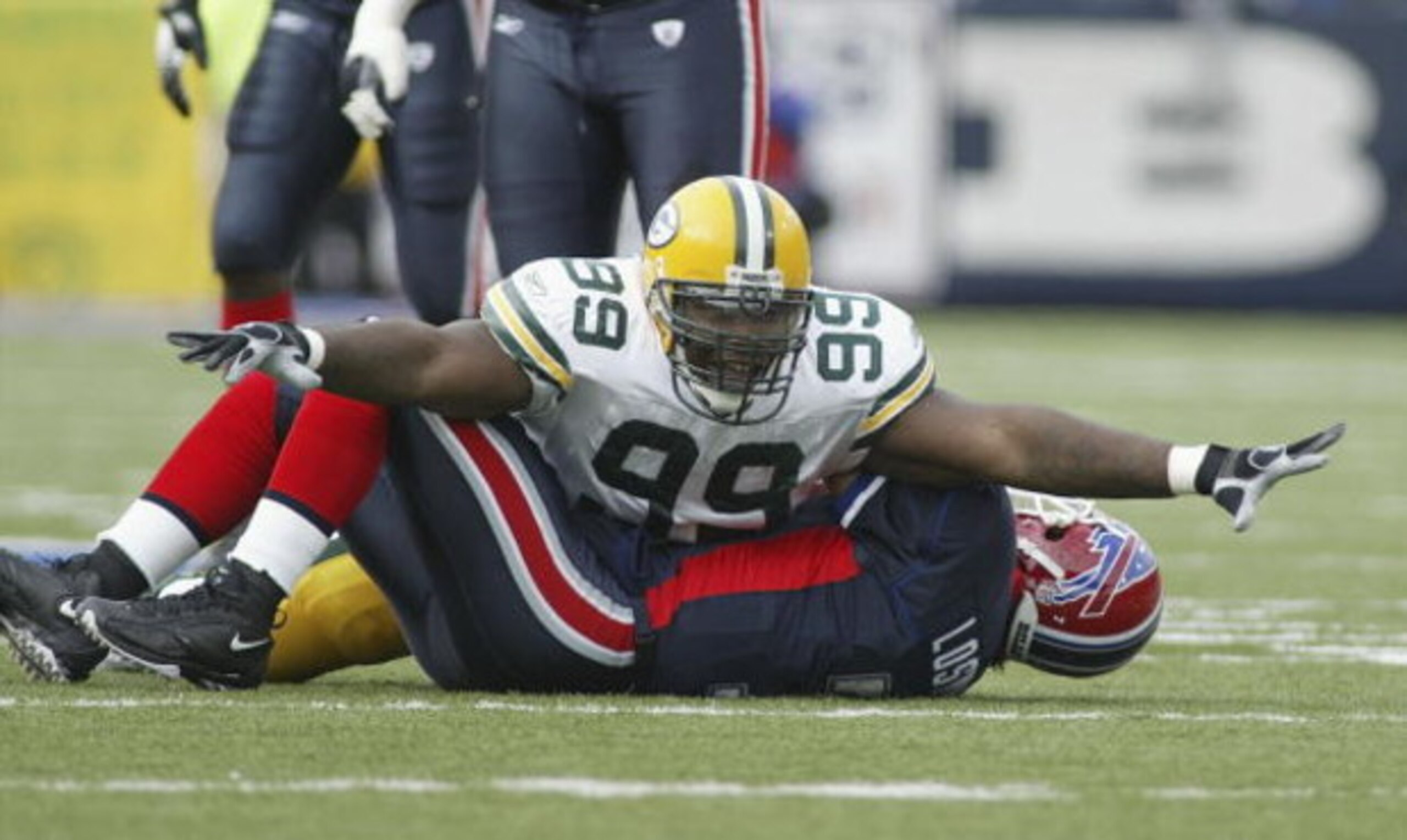 ORCHARD PARK, NY - NOVEMBER 05:  Corey Williams #99 of the Green Bay Packers celebrates his sack on JP Losman #7 of the Buffalo Bills November 5, 2006 at Ralph Wilson Stadium in Orchard Park, New York.  (Photo by Rick Stewart/Getty Images)