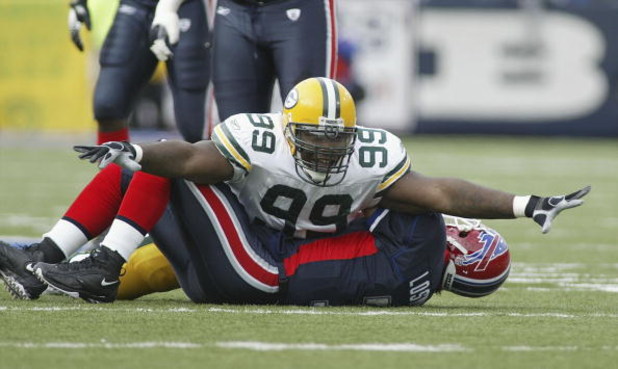 ORCHARD PARK, NY - NOVEMBER 05:  Corey Williams #99 of the Green Bay Packers celebrates his sack on JP Losman #7 of the Buffalo Bills November 5, 2006 at Ralph Wilson Stadium in Orchard Park, New York.  (Photo by Rick Stewart/Getty Images)