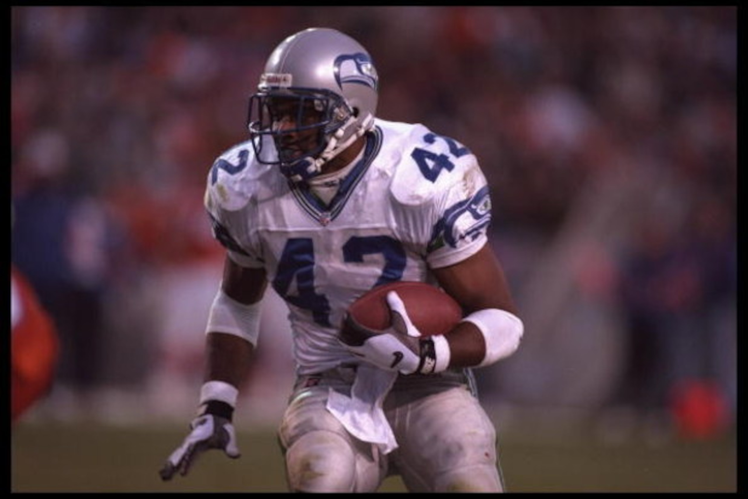 10 Dec 1995:  Running back Chris Warren #42 of the Seattle Seahawks carries his ball into the defense of the Denver Broncos at Mile High Stadium in Denver, Colorado. The Seahawks defeated the Broncos 31-27. Mandatory Credit:  Al Bello/Allsport