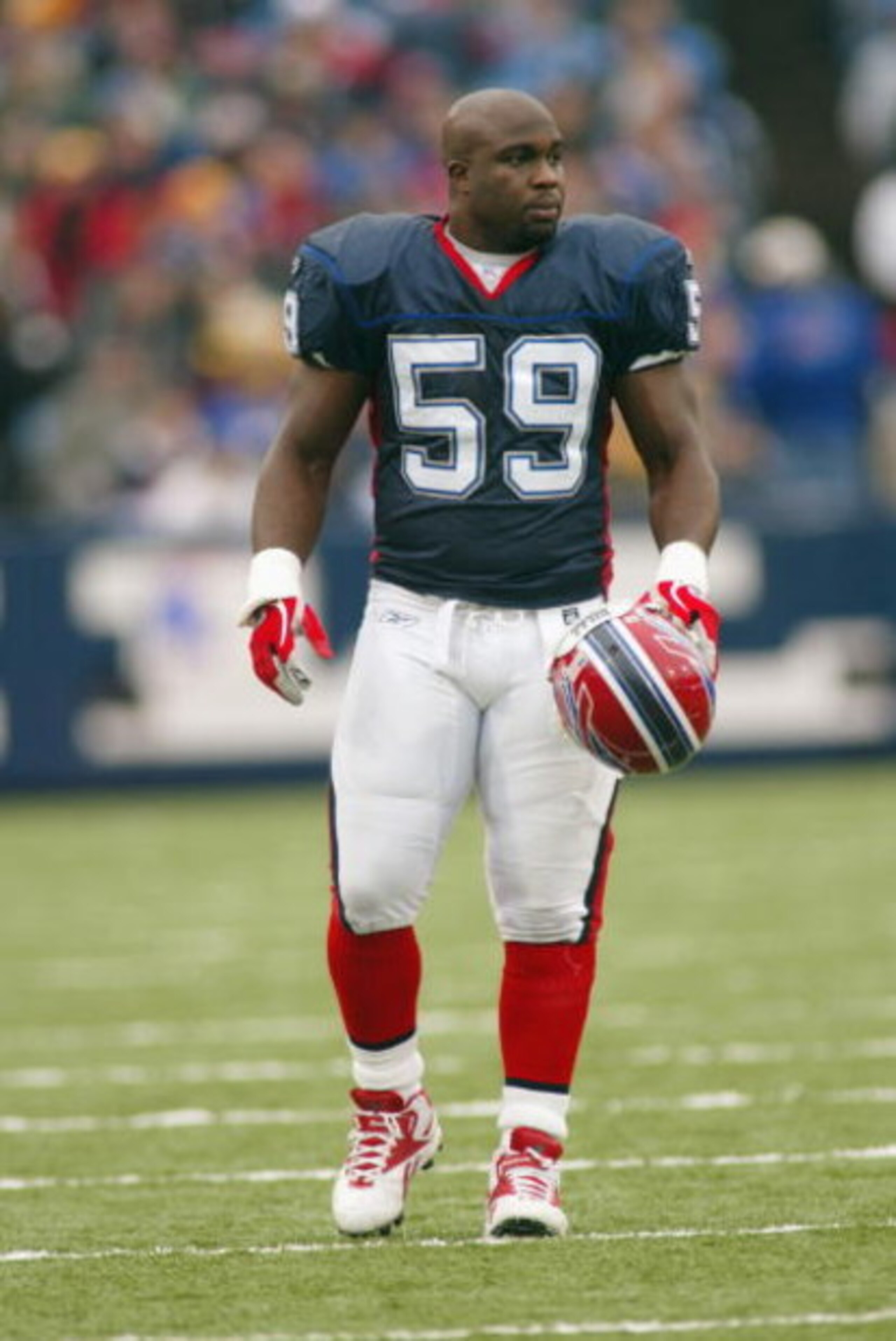 ORCHARD PARK, NY - NOVEMBER 16:  Linebacker London Fletcher #59 of the Buffalo Bills takes his helmet off during the game against the Houston Texans on November 16, 2003 at Ralph Wilson Stadium in Orchard Park, New York. The Texans defeated the Bills 12-1