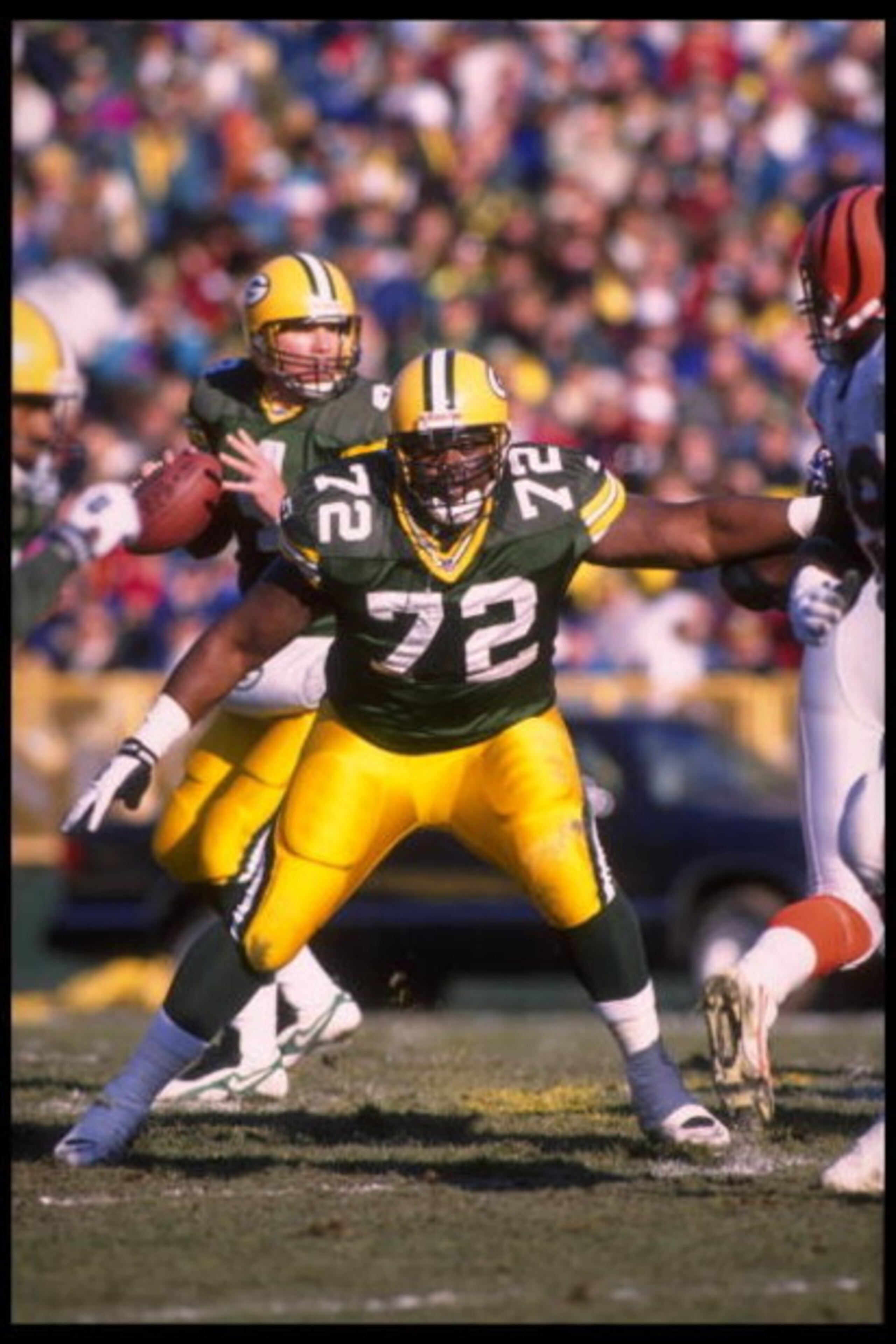 3 Dec 1995:  Quarterback Brett Favre #4 of the Green Bay Packers drops back behind tackle Earl Dotson #72 during the game against the Cincinnati Bengals at Lambeau Field in Green Bay, Wisconsin.  The Packers defeated the Bengals 24-10.  Mandatory Credit: