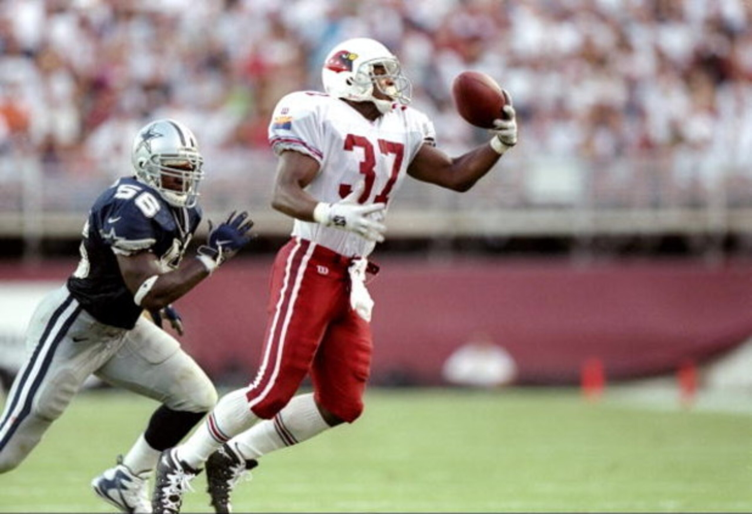 7 Sep 1997:  Running back Larry Centers #37 of the Arizona Cardinals catches a pass on the defense of Randall Godfrey of the Cowboys during the Cardinals 25-22 win over the Dallas Cowboys at Sun Devil Stadium in Tempe, Arizona. Mandatory Credit: Brian Bah