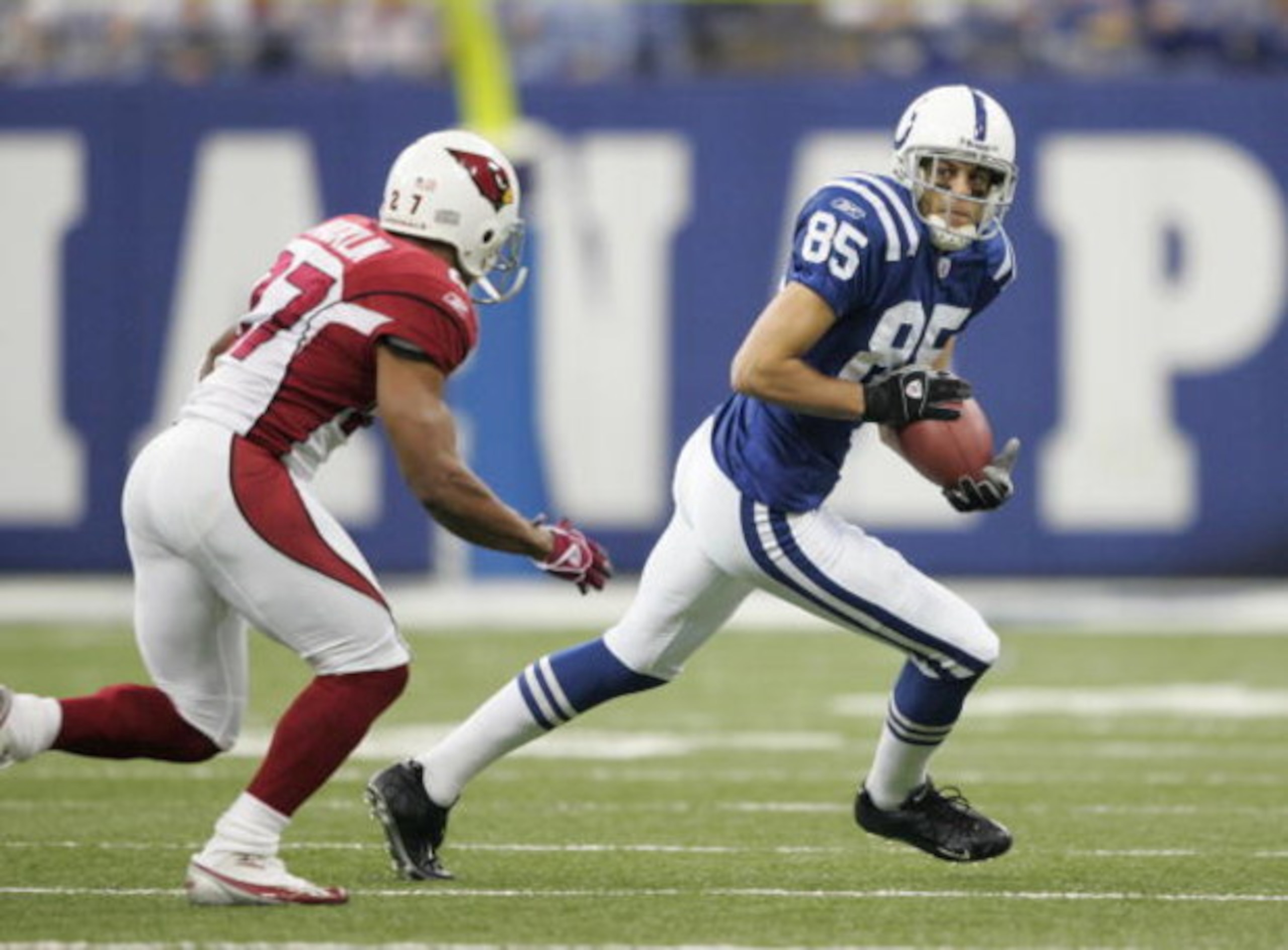 INDIANAPOLIS - JANUARY 01: Aaron Moorehead #85 of the Indianapolis Colts carries the ball against David Macklin #27 of the Arizona Cardinals at the RCA Dome on January 1,2006 in Indianapolis, Indiana. The 17-13 Colts win was the first game back for Dungy 