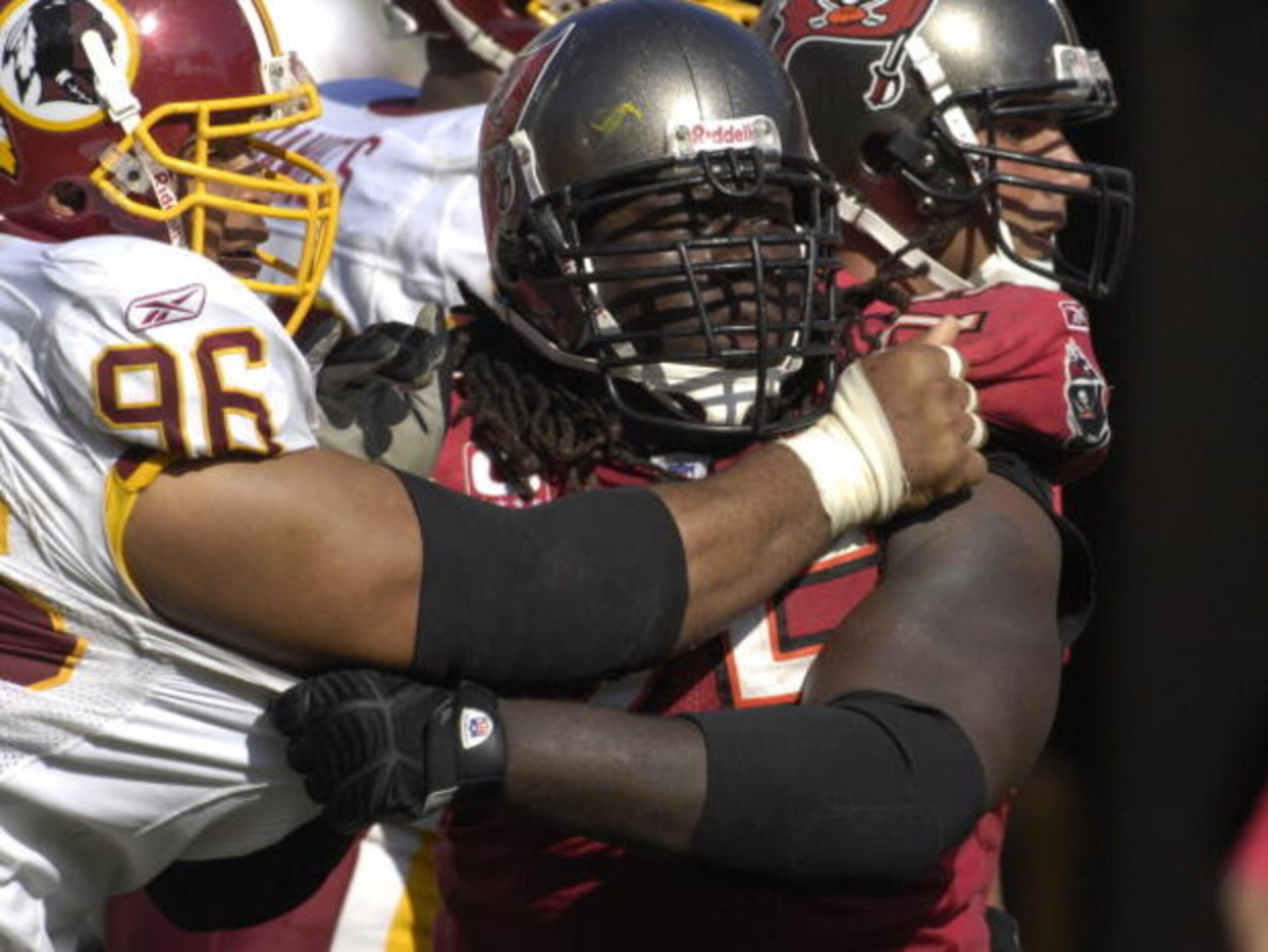TAMPA, FL - NOVEMBER 25: Guard Davin Joseph #75 of the Tampa Bay Buccaneers blocks against defensive tackle Cornelius Griffin #96 of the Washington Redskins at the Raymond James Stadium on November 25, 2007 in Tampa, Florida. The Bucs won 19-13.  (Photo b