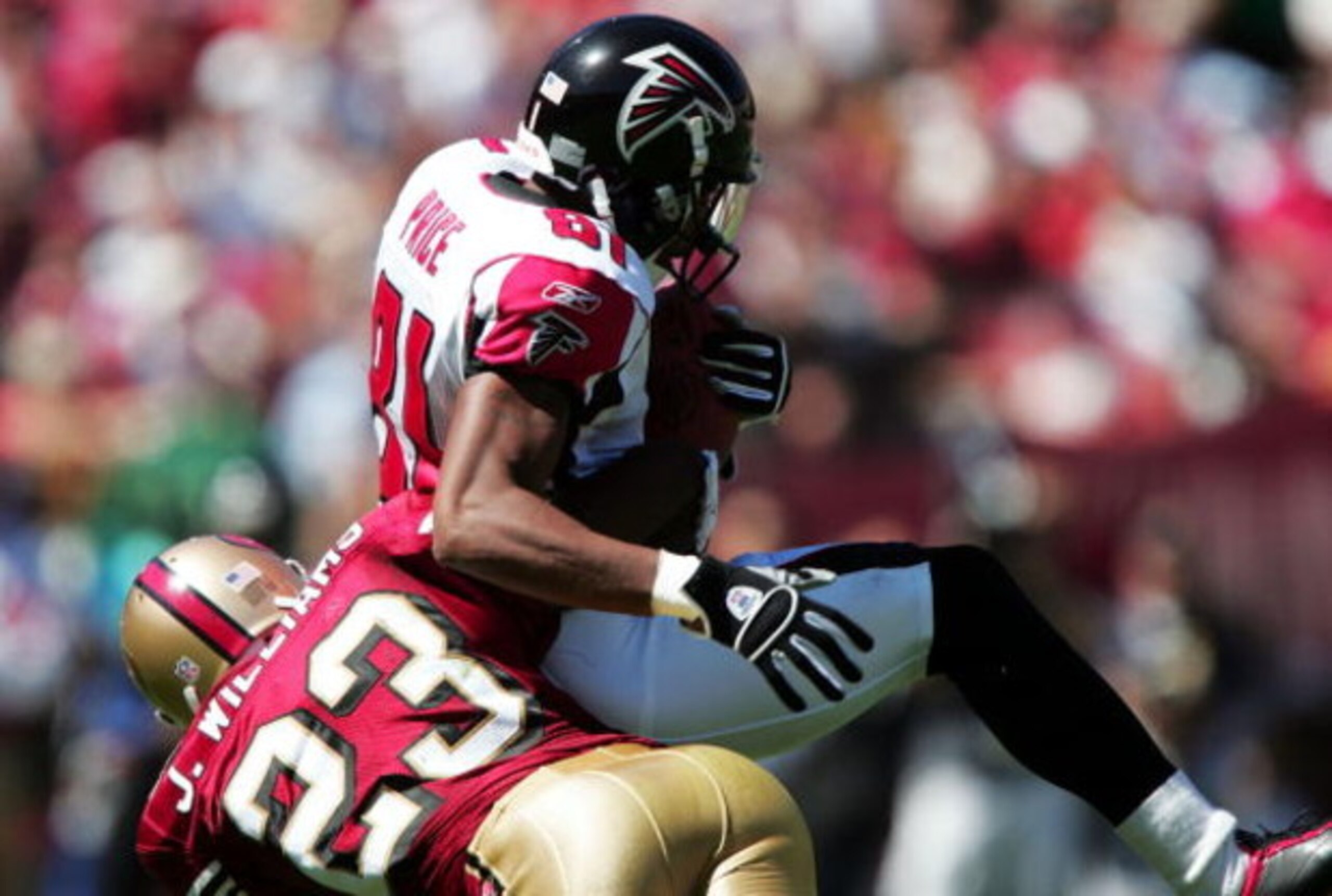 SAN FRANCISCO - SEPTEMBER 12:  Peerless Price #81 of the Atlanta Falcons catches a pass over Jimmy Williams #23 of the San Francisco 49ers on September 12, 2004 at 3Com Park in San Francisco, California.  (Photo by Jed Jacobsohn/Getty Images)