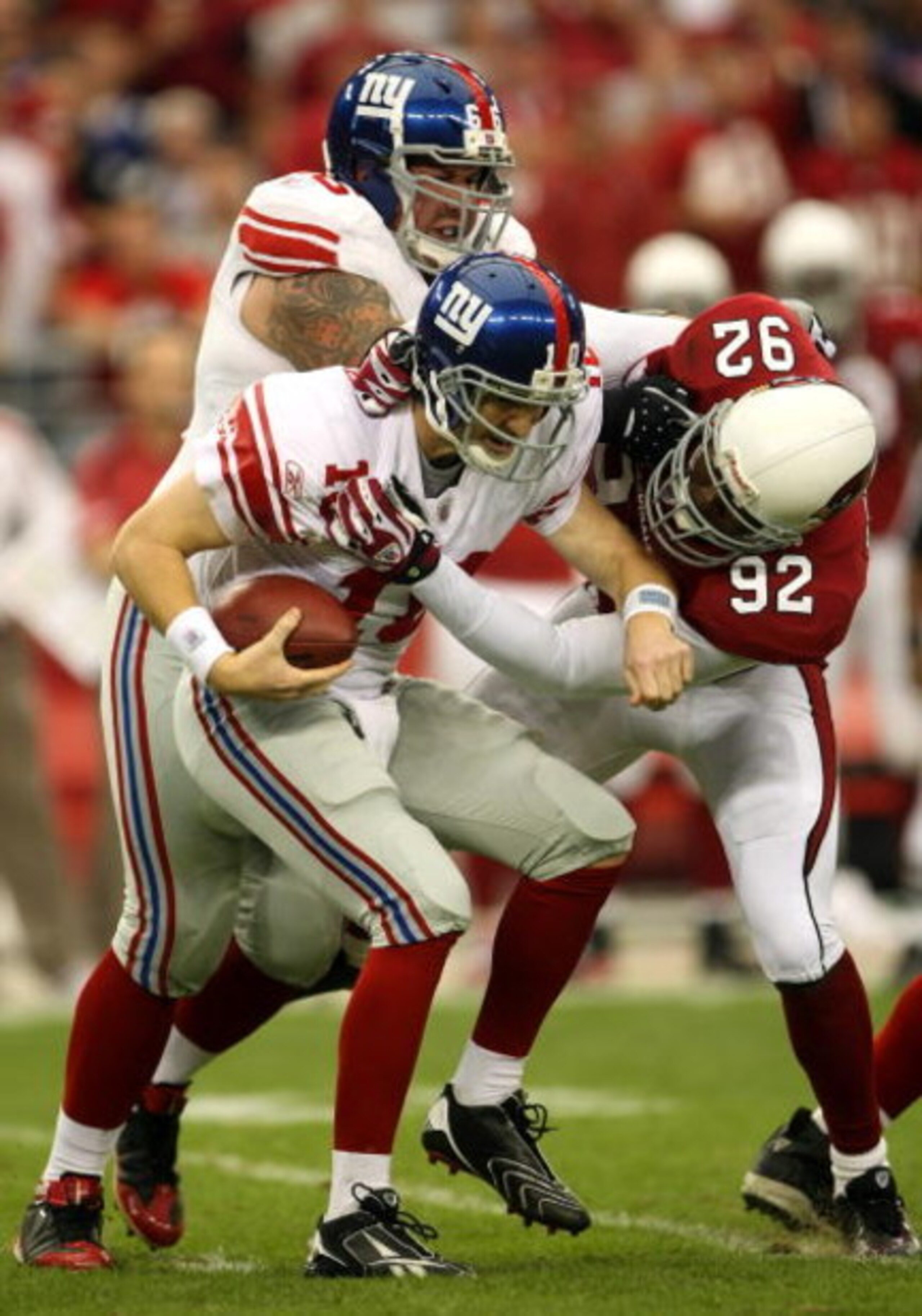 GLENDALE, AZ - NOVEMBER 23: Bertrand Berry #92 of the Arizona Cardinals sacks quarterback Eli Manning #10 of the New York Giants in front of Giants tackle David Diehl #66 on November 23, 2008 at University of Phoenix Stadium in Glendale, Arizona.  (Photo 
