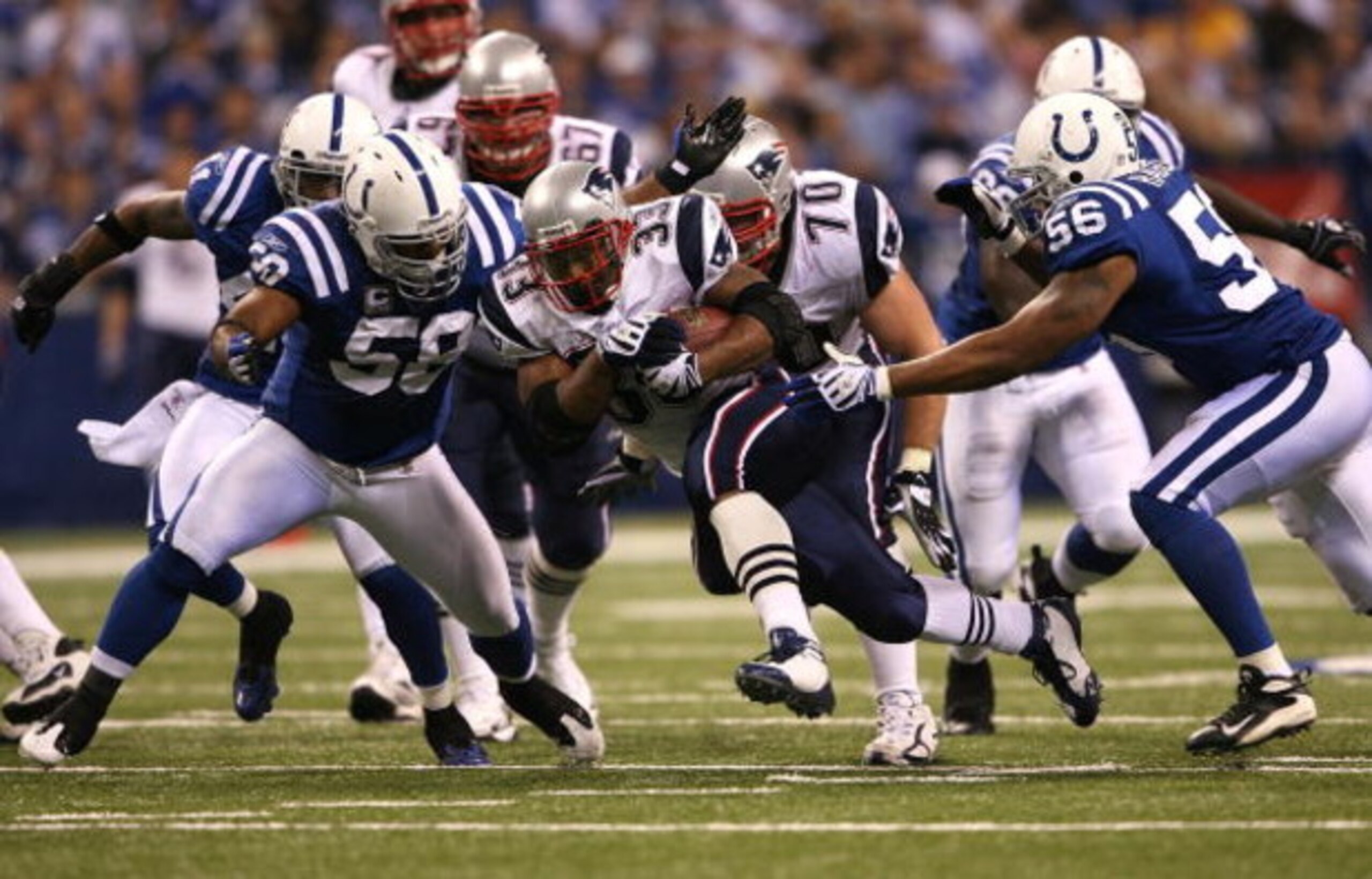 INDIANAPOLIS - NOVEMBER 02:  Kevin Faulk #33 of the New England Patriots runs the ball against Gary Brackett #58 and Tyjuan Hagler #56 og the Indianapolis Colts at Lucas Oil Stadium on November 2, 2008 in Indianapolis, Indiana.  (Photo by Andy Lyons/Getty