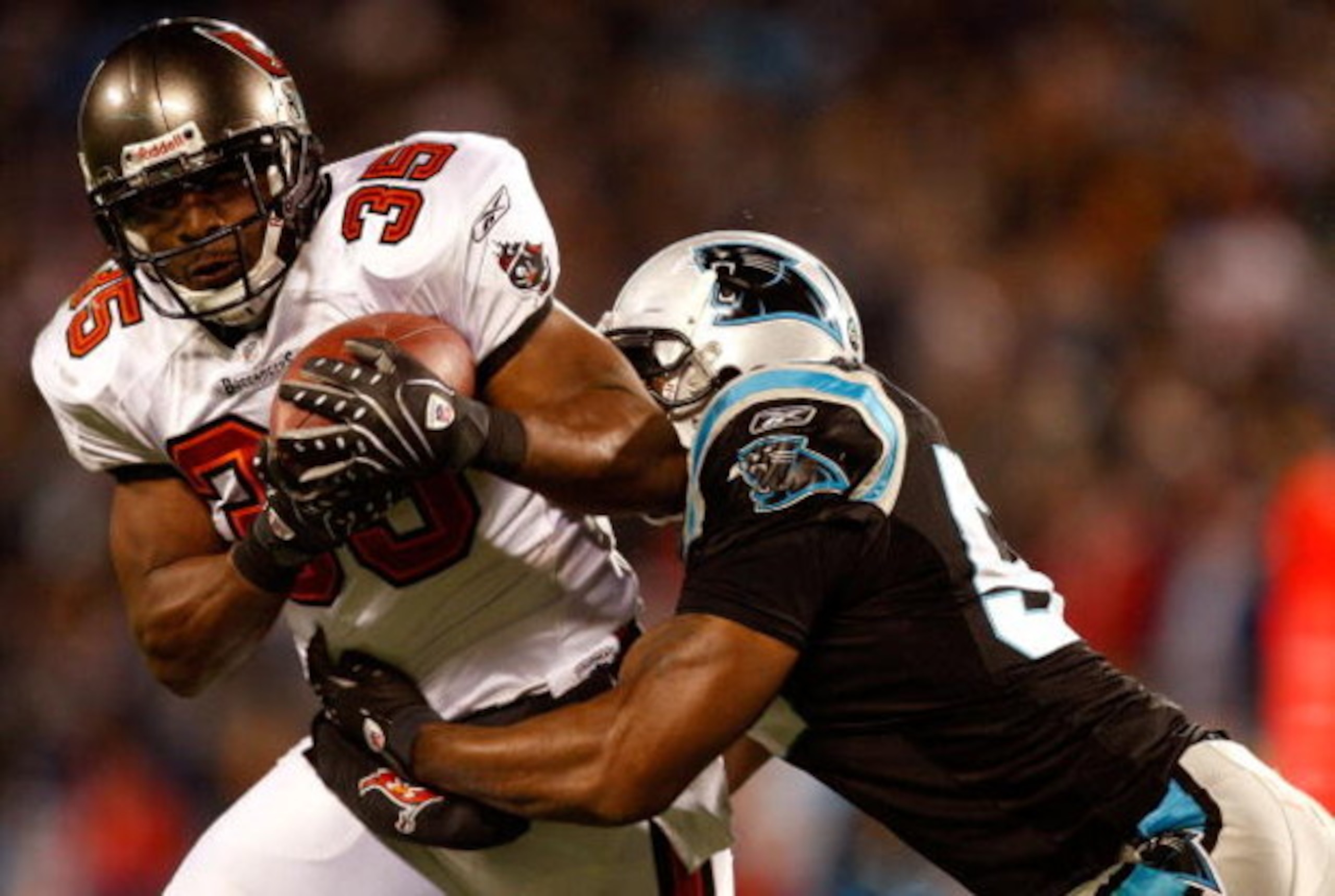 CHARLOTTE, NC - DECEMBER 08:  B.J. Askew #35 of the Tampa Bay Buccaneers is tackled by Na'il Diggs #53 of the Carolina Panthers during their game at Bank of America Stadium on December 8, 2008 in Charlotte, North Carolina.  (Photo by Streeter Lecka/Getty 