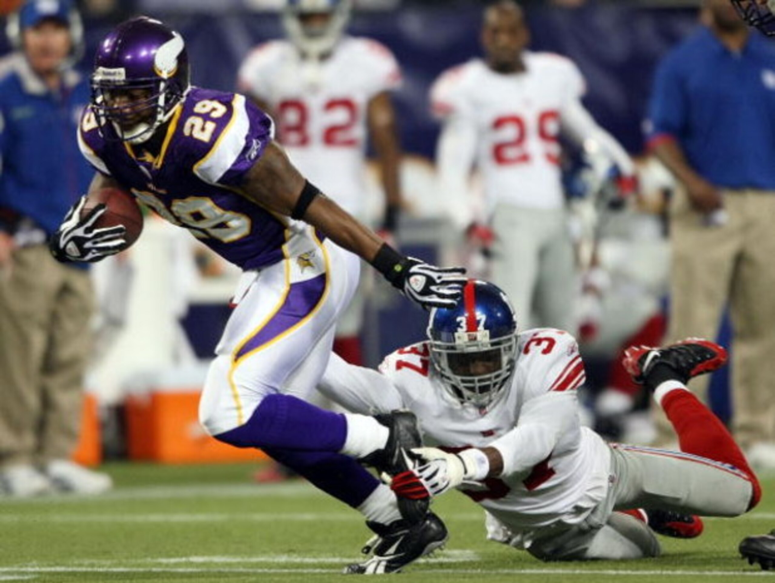 MINNEAPOLIS - DECEMBER 28:   Chester Taylor #29 of the Minnesota Vikings carries the ball for a first down as James Butler #37 of the New York Giants defends on December 28, 2008 at the Hubert H. Humphrey Metrodome in Minneapolis, Minnesota. The Vikings d
