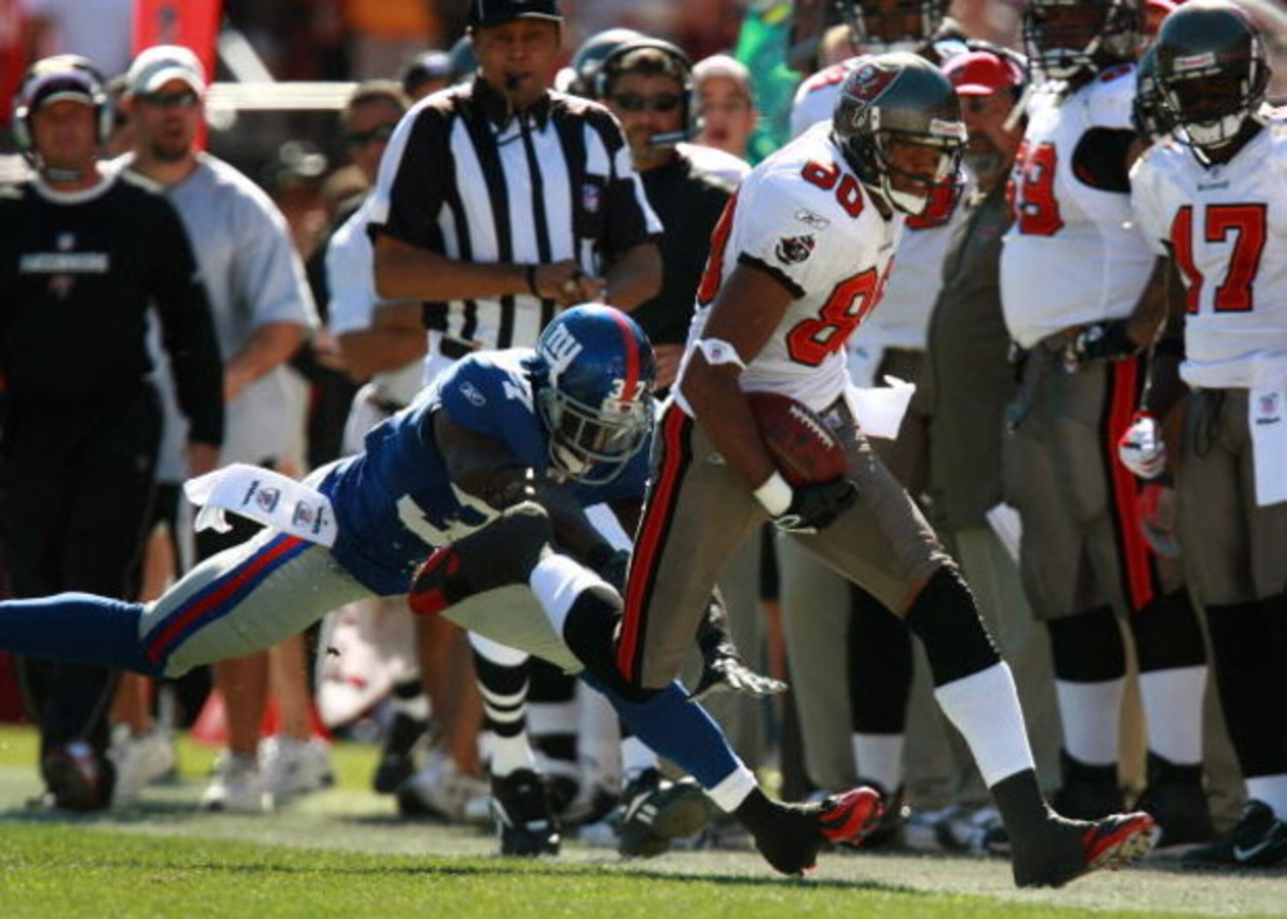 TAMPA, FL - JANUARY 06:  Safety James Butler #37 of the New York Giants tries to stop wide receiver Michael Clayton #80 of the Tampa Bay Buccaneers in the first quarter of the NFC Wild Card game at Raymond James Stadium on January 6, 2008 in Tampa, Florid