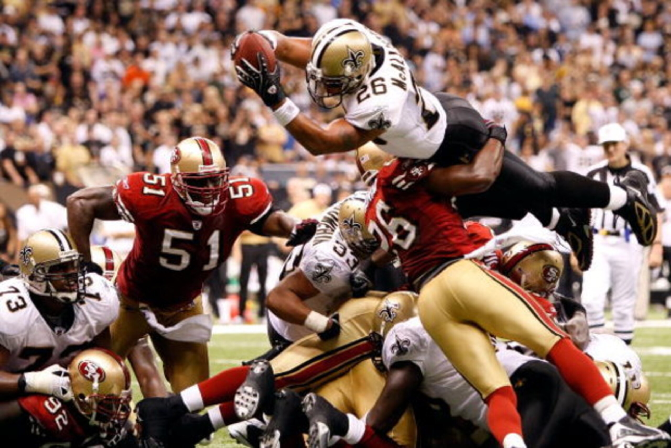 NEW ORLEANS - SEPTEMBER 28:  Deuce McAllister #26 of the New Orleans Saints scores a touchdown over Mark Roman #26 of the San Francisco 49ers on September 28 2008 at the Superdome in New Orleans, Louisiana.  The Saints defeated the 49ers 31-17.  (Photo by