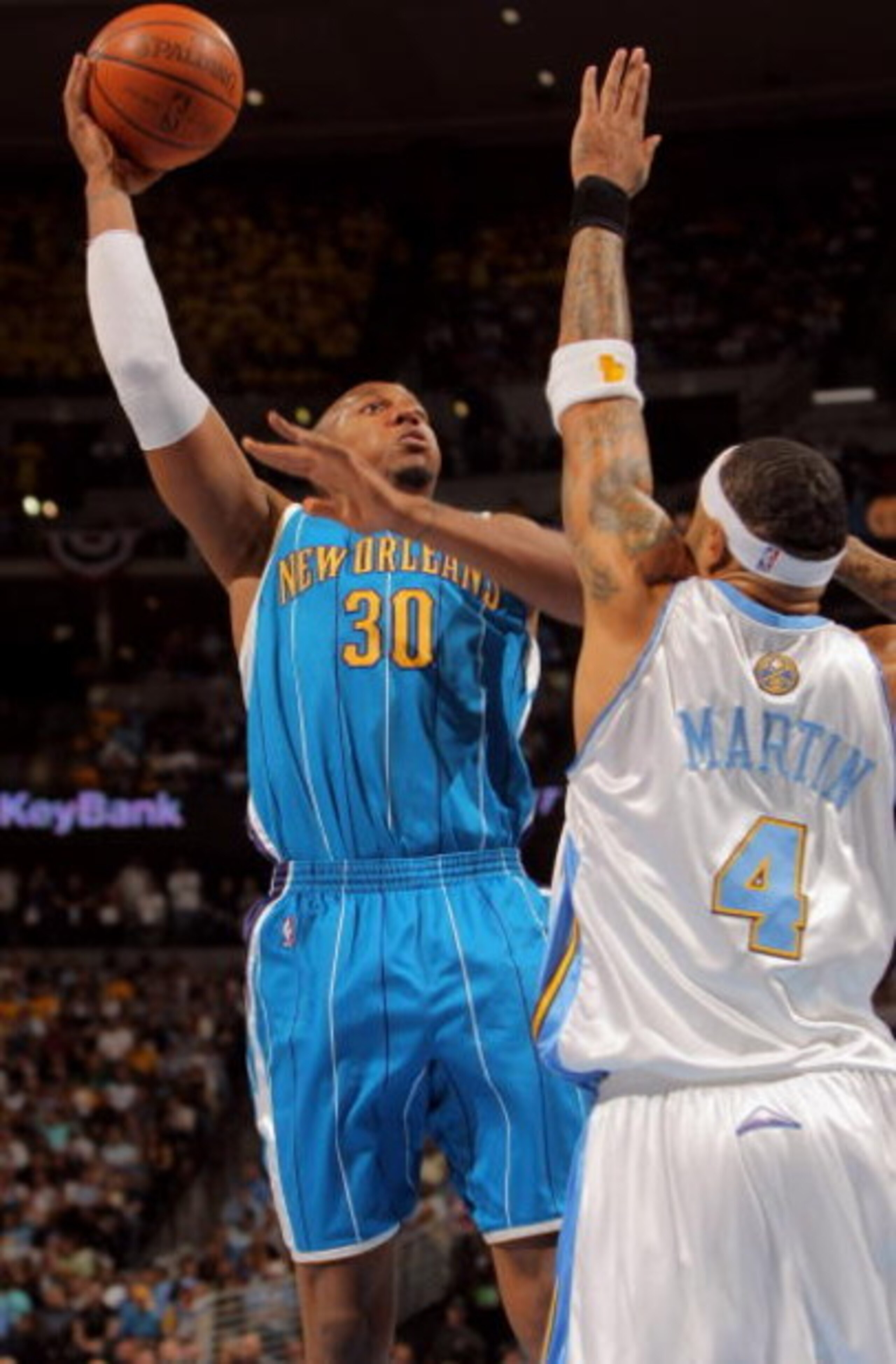 DENVER - APRIL 29:  David West #30 of the New Orleans Hornets shoots over Kenyon Martin #4 of the Denver Nuggets in Game Five of the Western Conference Quarterfinals during the 2009 NBA Playoffs at Pepsi Center on April 29, 2009 in Denver, Colorado. The N