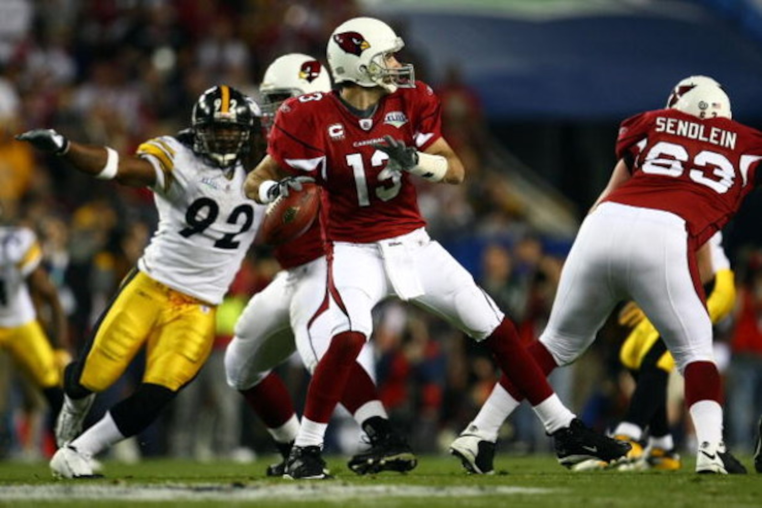 TAMPA, FL - FEBRUARY 01:  Quarterback Kurt Warner #13 of the Arizona Cardinals looks to pass as James Harrison #92 of the Pittsburgh Steelers comes from the weak side during Super Bowl XLIII on February 1, 2009 at Raymond James Stadium in Tampa, Florida. 