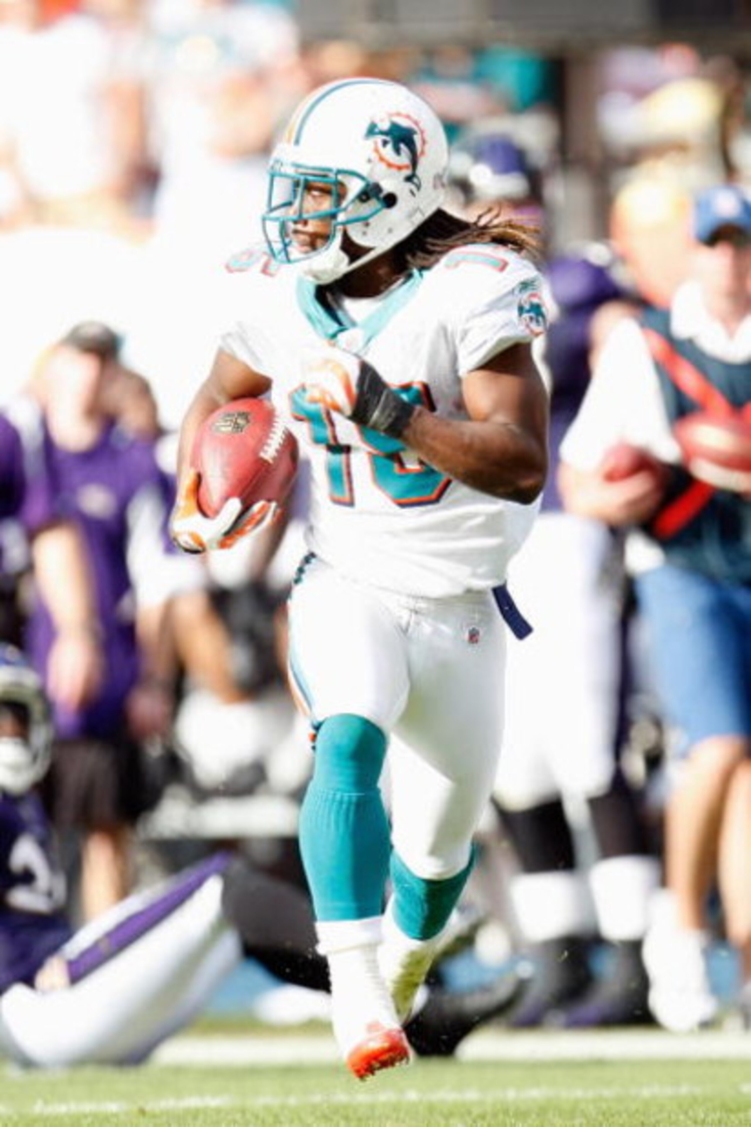 MIAMI - JANUARY 4:  Davone Bess #15 of the Miami Dolphins carries the ball during an AFC Wild Card playoff game against the Baltimore Ravens on January 4, 2009 at Dolphin Stadium in Miami, Florida. (Photo by Gregory Shamus/Getty Images)