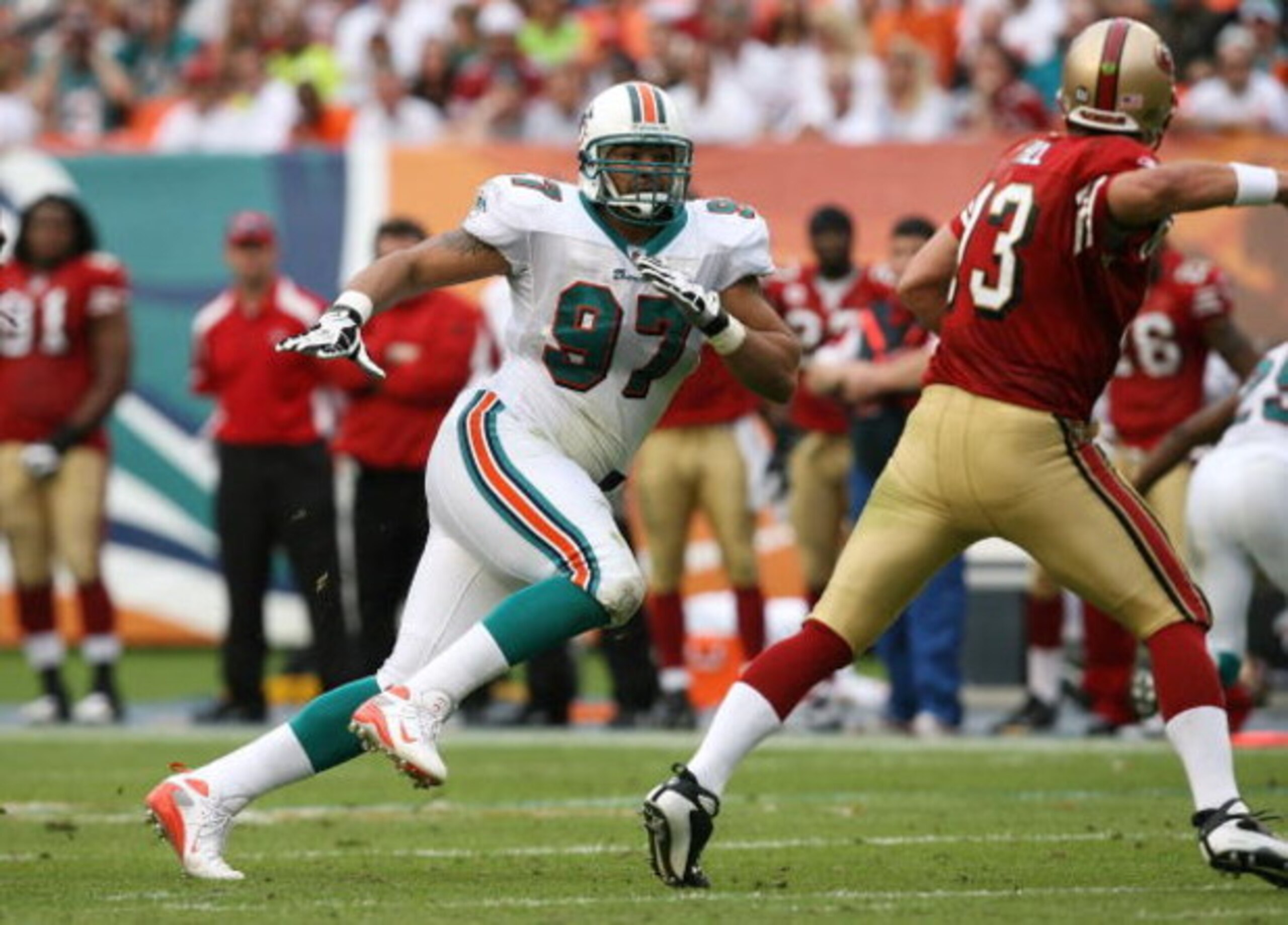 MIAMI - DECEMBER 14:  Defensive end Phillip Merling #97 of the Miami Dolphins chases quarterback Shaun Hill #13 of the San Francisco 49ers at Dolphin Stadium on December 14, 2008 in Miami, Florida. The Dolphins defeated the 49ers 14-9.  (Photo by Doug Ben