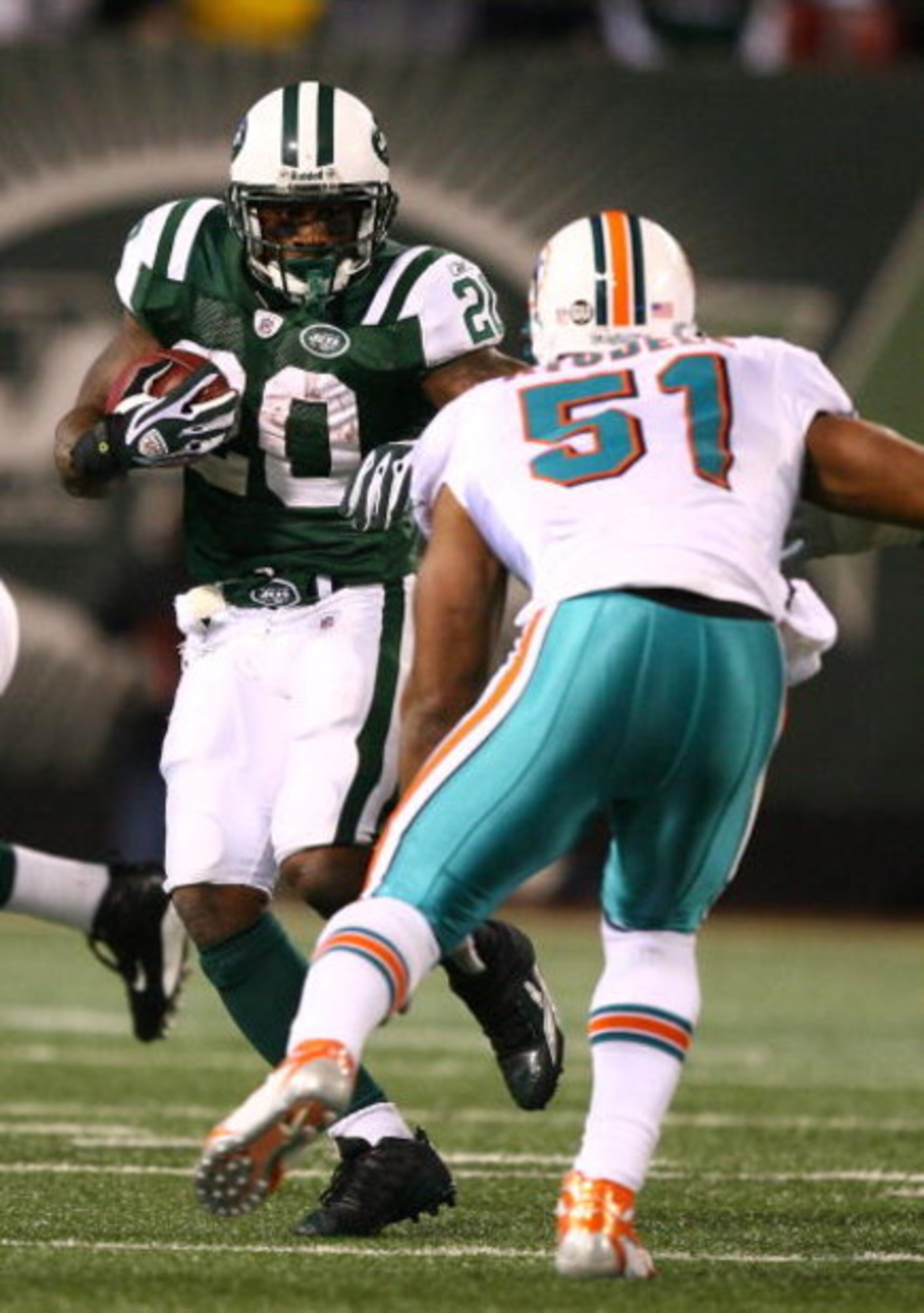 EAST RUTHERFORD, NJ - DECEMBER 28:  Thomas Jones #20 of The New York Jets runs the ball as Akin Ayodele #51 of The Miami Dolphins attempts the tackle during their game on December 28, 2008 at Giants Stadium in East Rutherford, New Jersey.  (Photo by Al Be