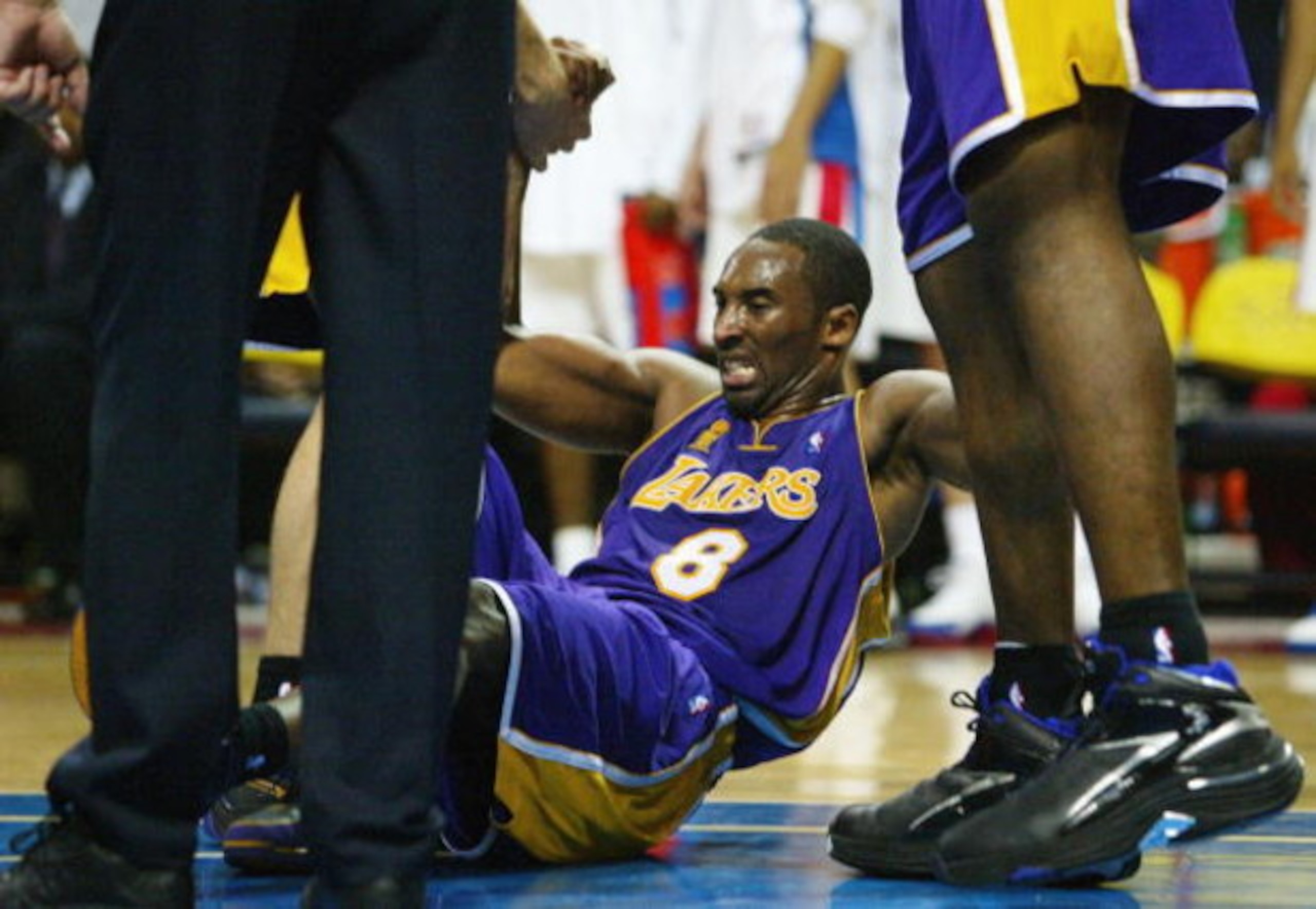 AUBURN HILLS, MI - JUNE 15: Kobe Bryant #8 of the Los Angeles Lakers is helped up off the floor by teammate Shaquille O'Neal #34 (R) and a referee (L) after being fouled by the Detroit Pistons in the forth quarter of game five of the 2004 NBA Finals on J AUBURN HILLS, MI - JUNE 15: Kobe Bryant #8 of the Los Angeles Lakers is helped up off the floor by teammate Shaquille O'Neal #34 (R) and a referee (L) after being fouled by the Detroit Pistons in the forth quarter of game five of the 2004 NBA Finals on J